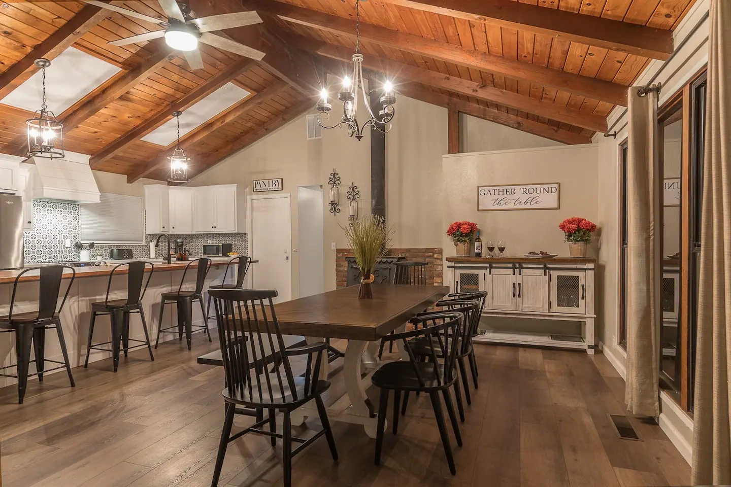 Gather around this stunning farmhouse dining space where exposed beams and warm wood create the perfect atmosphere for your memorable meals together.