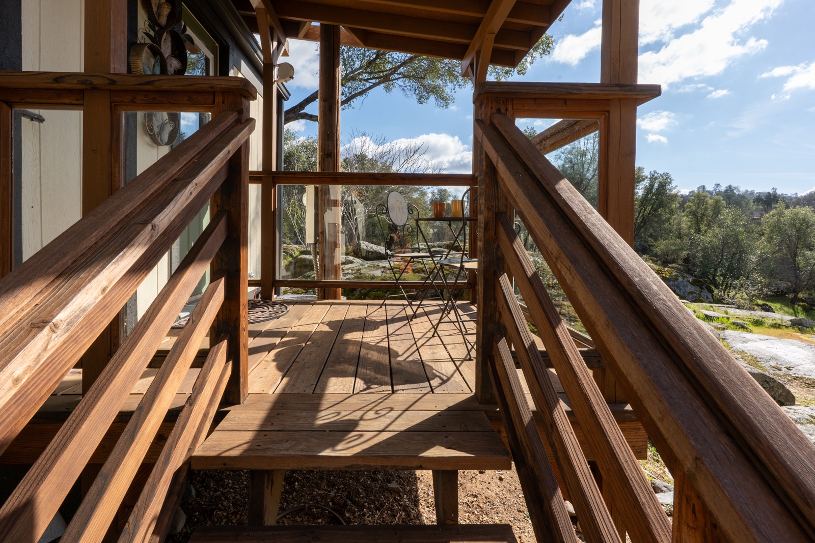 Private wooden back patio surrounded by natural beauty.