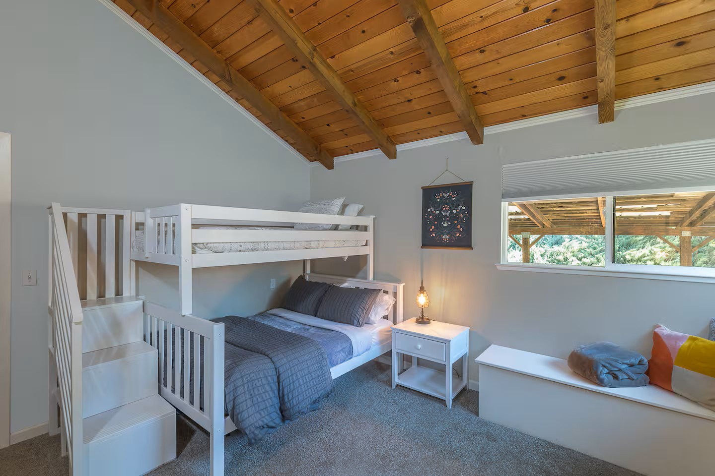 Your cozy bunk room features rustic wood beam ceilings and comfortable sleeping arrangements perfect for family stays or group getaways.