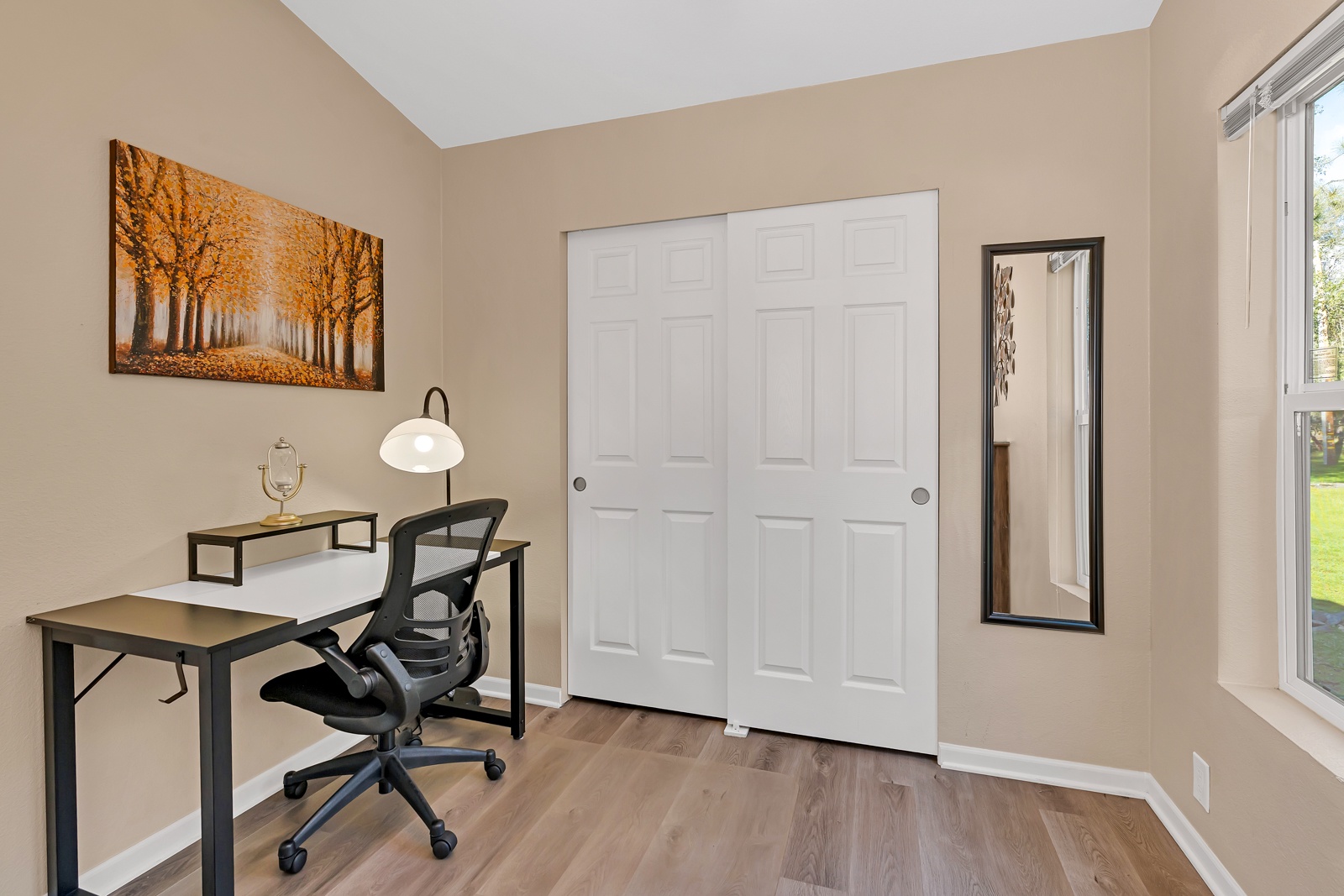 Extra large second bedroom with desk and comfy chair.