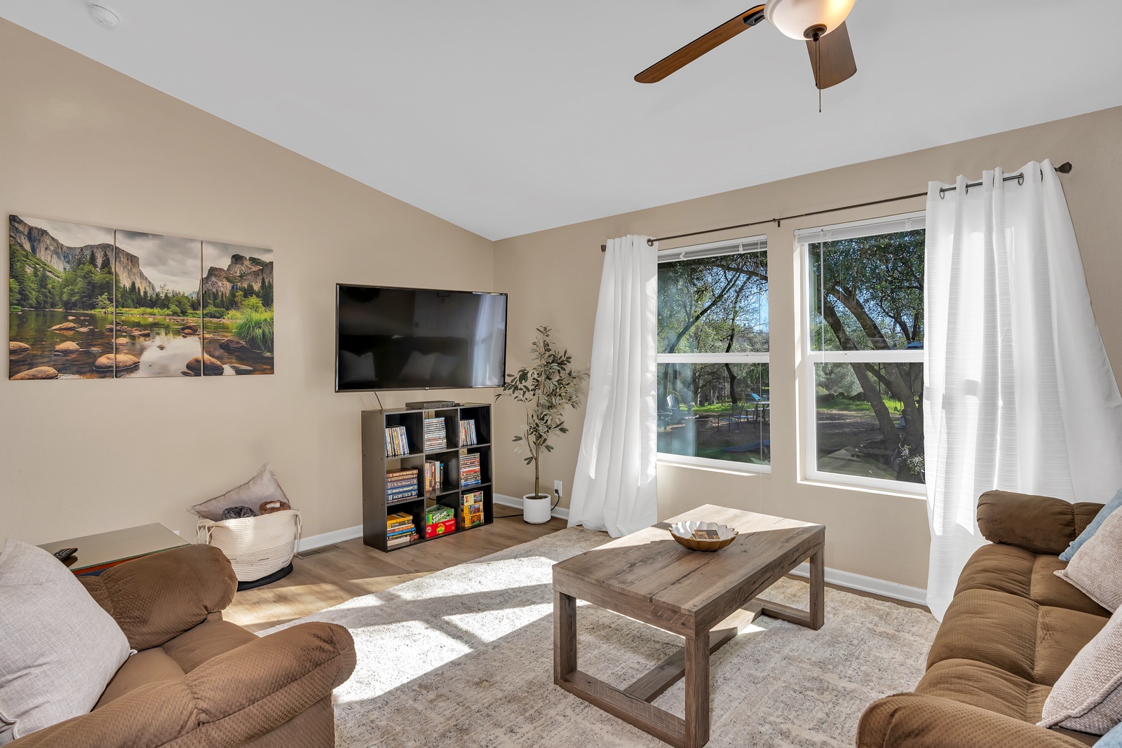Sink into the plush reclining sofa and enjoy movie nights on the large TV in this bright, airy living room with blackout curtains.