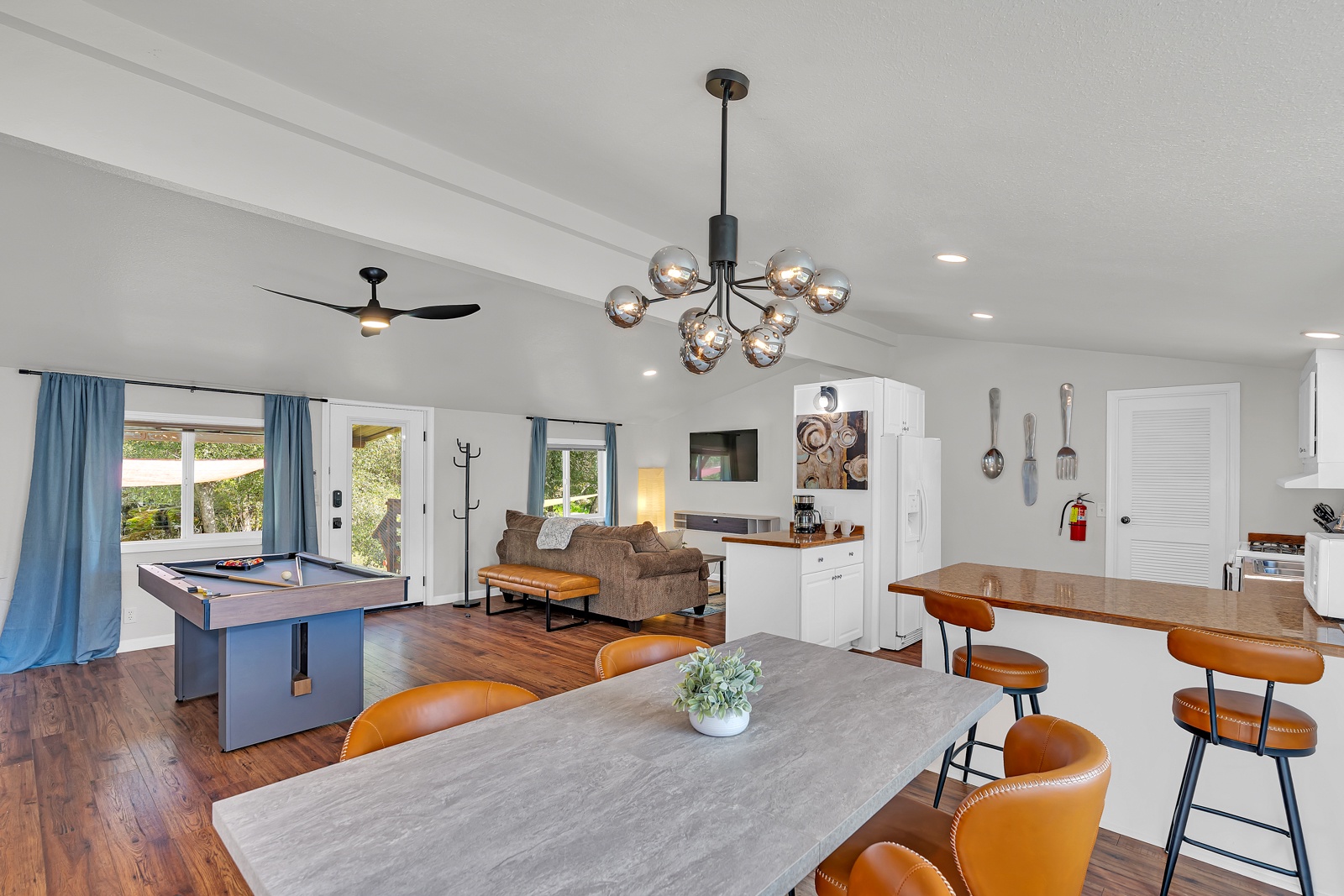 Your open-concept retreat features a stylish pool table, cozy seating, and a fully equipped kitchen—perfect for entertaining friends and family.