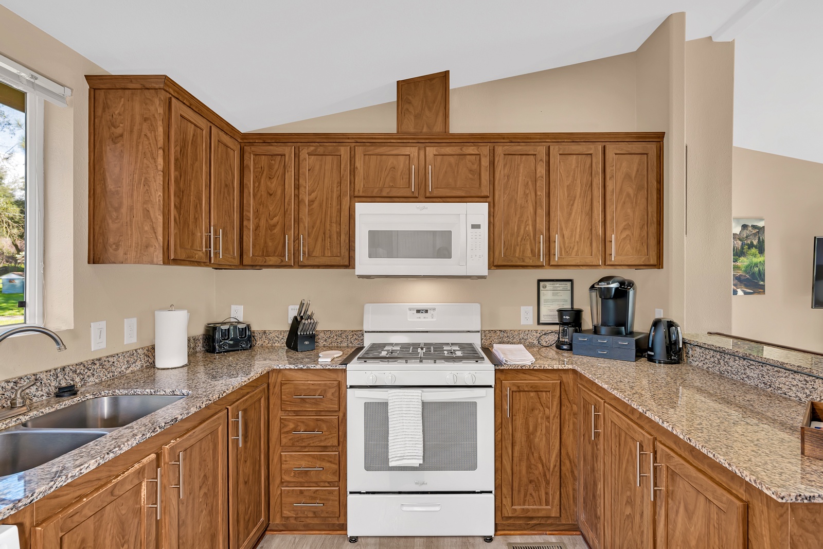 Your fully-equipped kitchen awaits with rich wood cabinetry, and modern appliances.