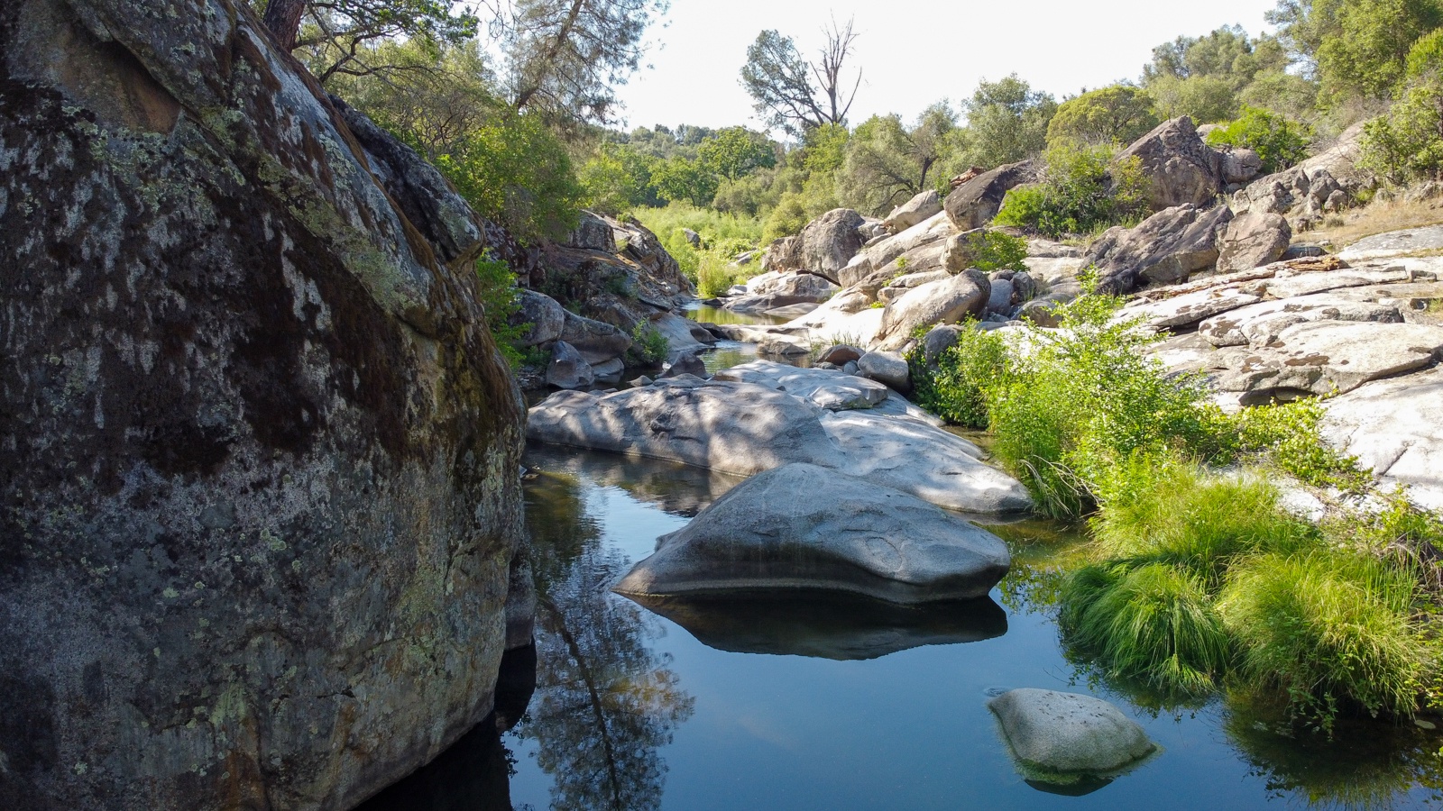Admire granite boulders and lush vegetation on the property. perty.