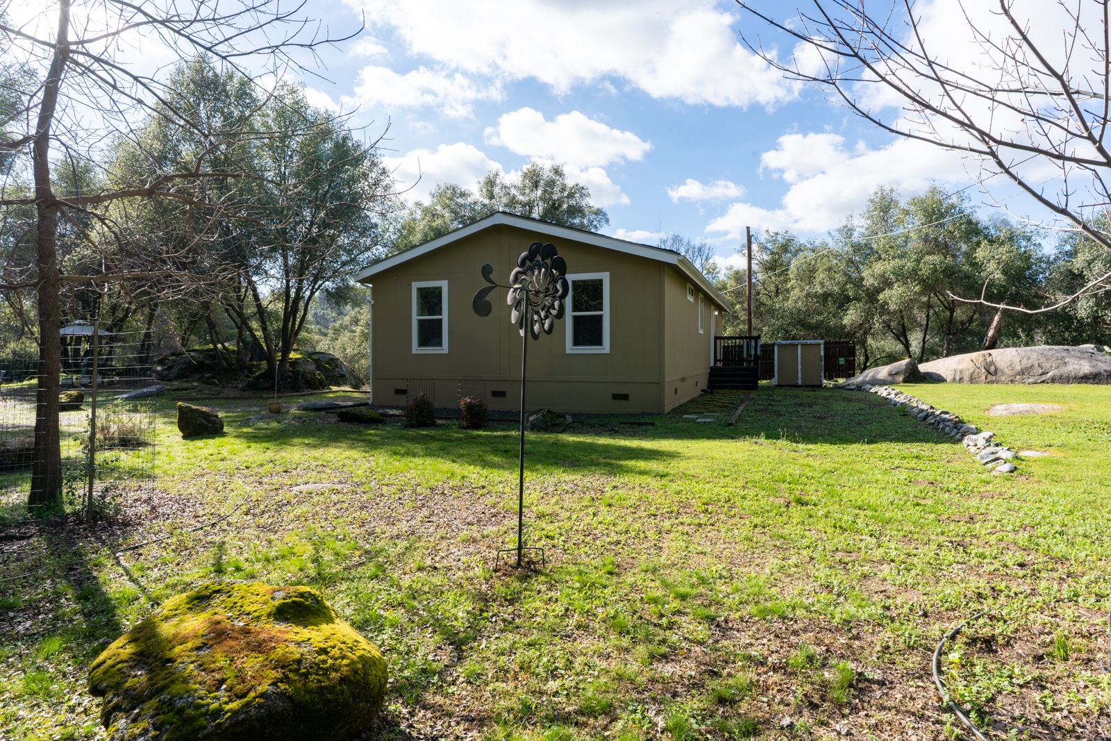 Cozy retreat nestled among mature trees and natural landscaping, offering a peaceful countryside setting for your getaway.