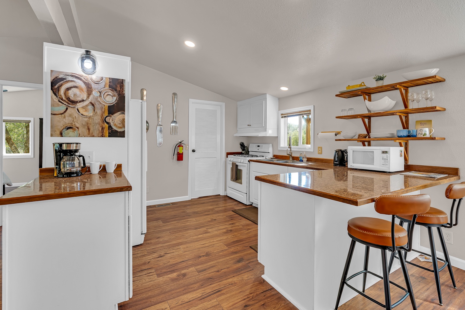 Your fully equipped kitchen, with breakfast bar seating, so you can stay-in and cook satisfying meals.