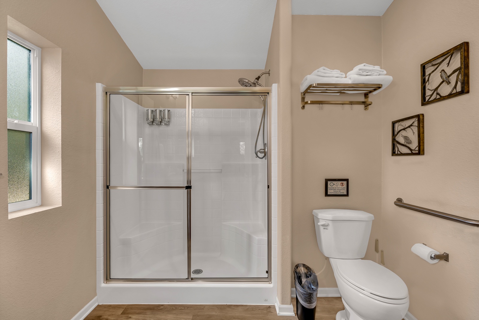 En-suite shower has a spacious walk-in shower with seat and thoughtful amenities for your comfort.