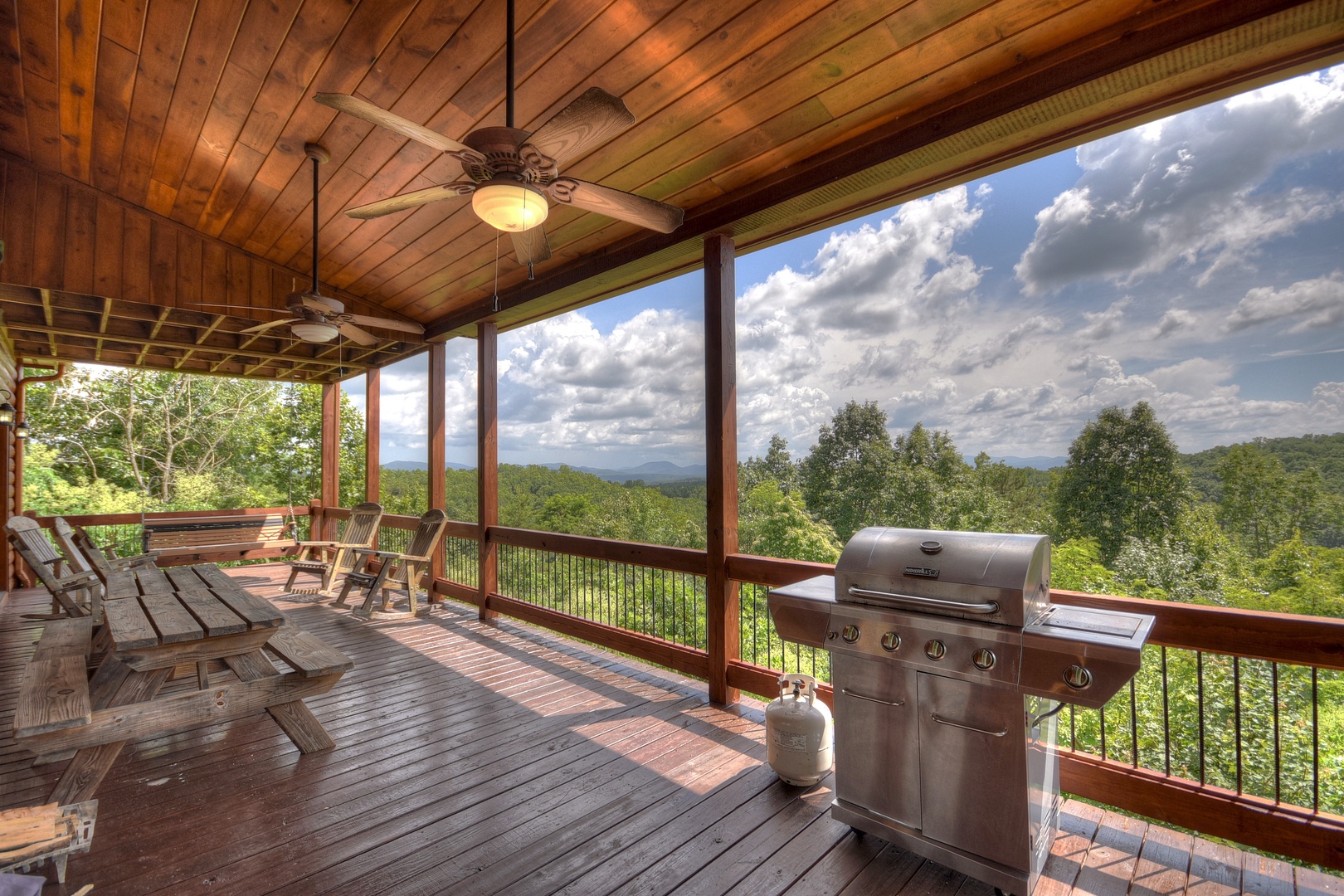Above Ravens Ridge- Entry level deck area with a grill