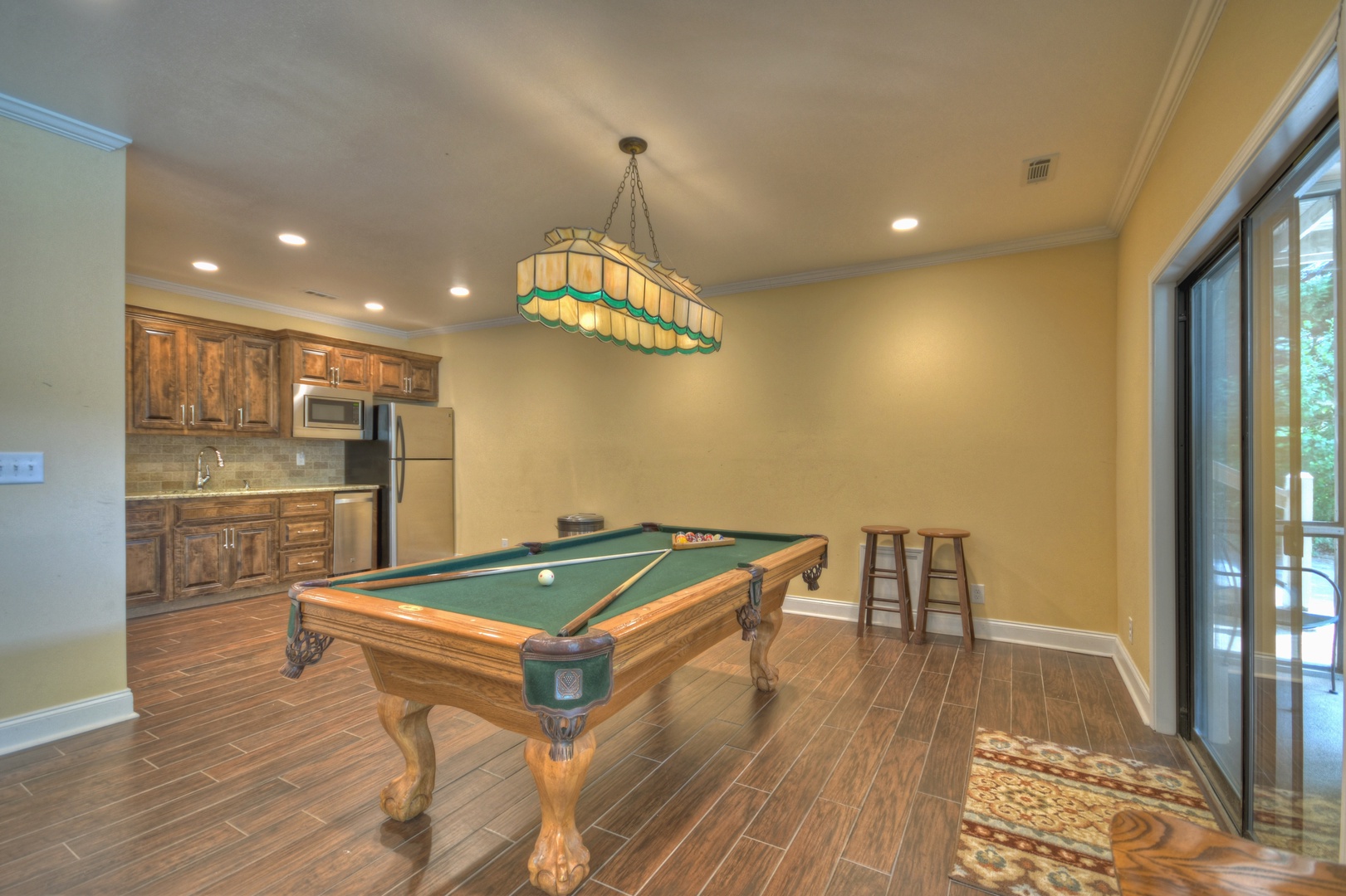 Jump Right In- Lower level game area with a pool table