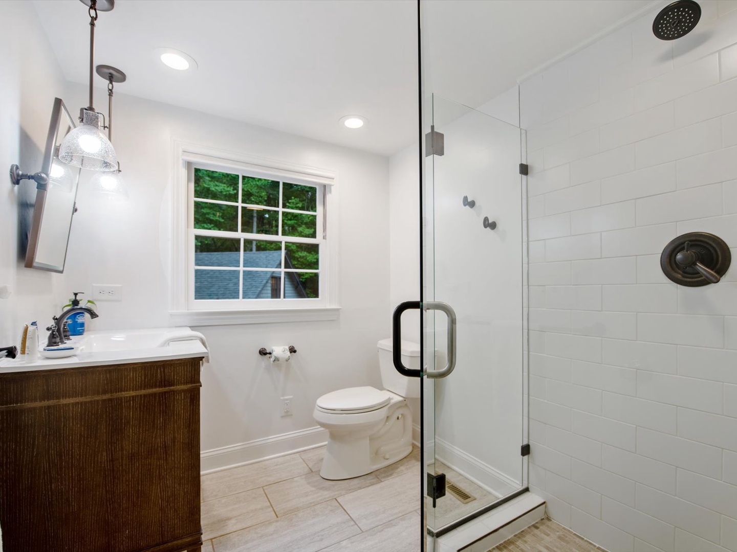 Gleesome Inn- Upper level bathroom with a walk in shower, toilet and sink
