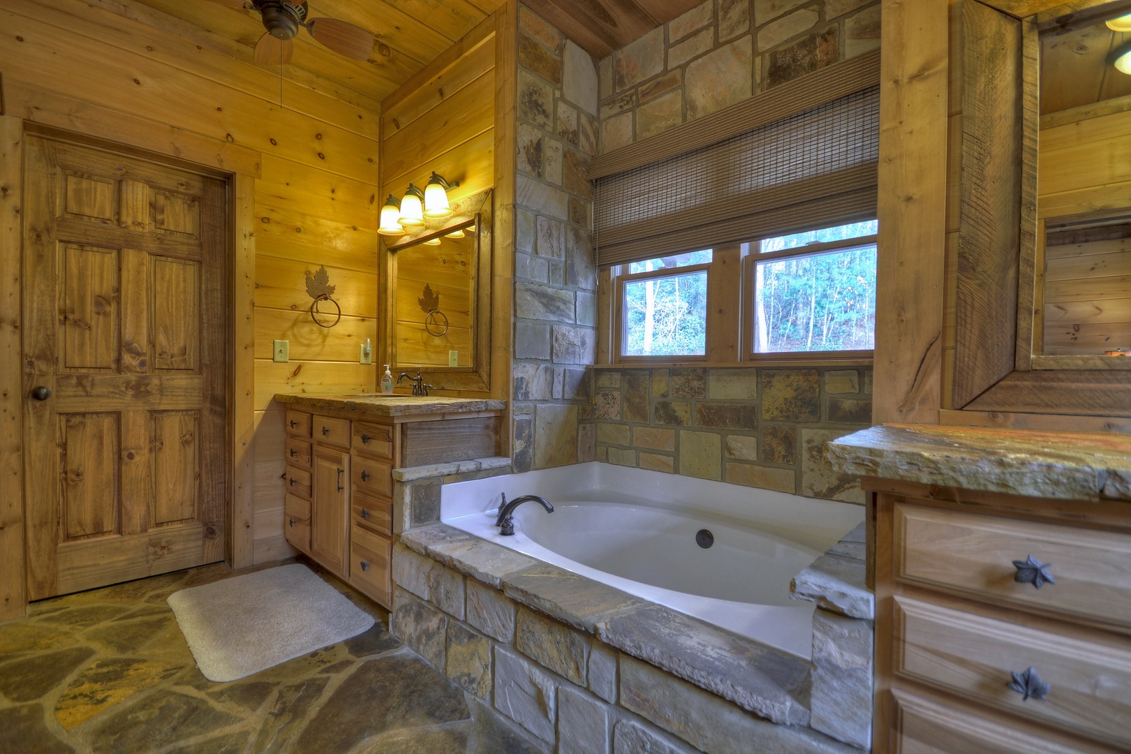 Reel Creek Lodge- Private bathroom with a stone garden tub and vanity sinks