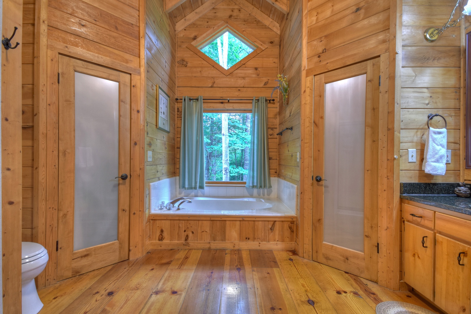 Falling Leaf- Master bathroom with a soaker tub and window view