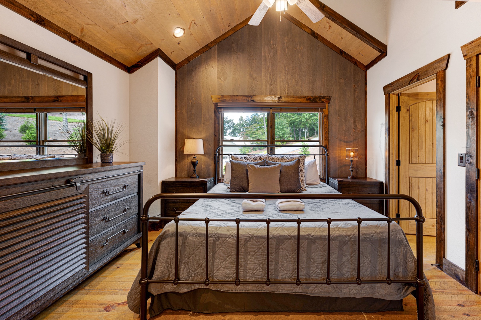 Mountain Echoes- Upper level king bedroom with a dresser and mirror
