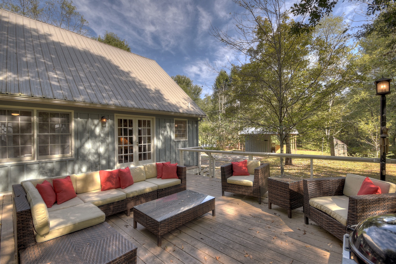 Sipping Rise- Back deck seating area with plenty of outdoor furniture and cabin access door