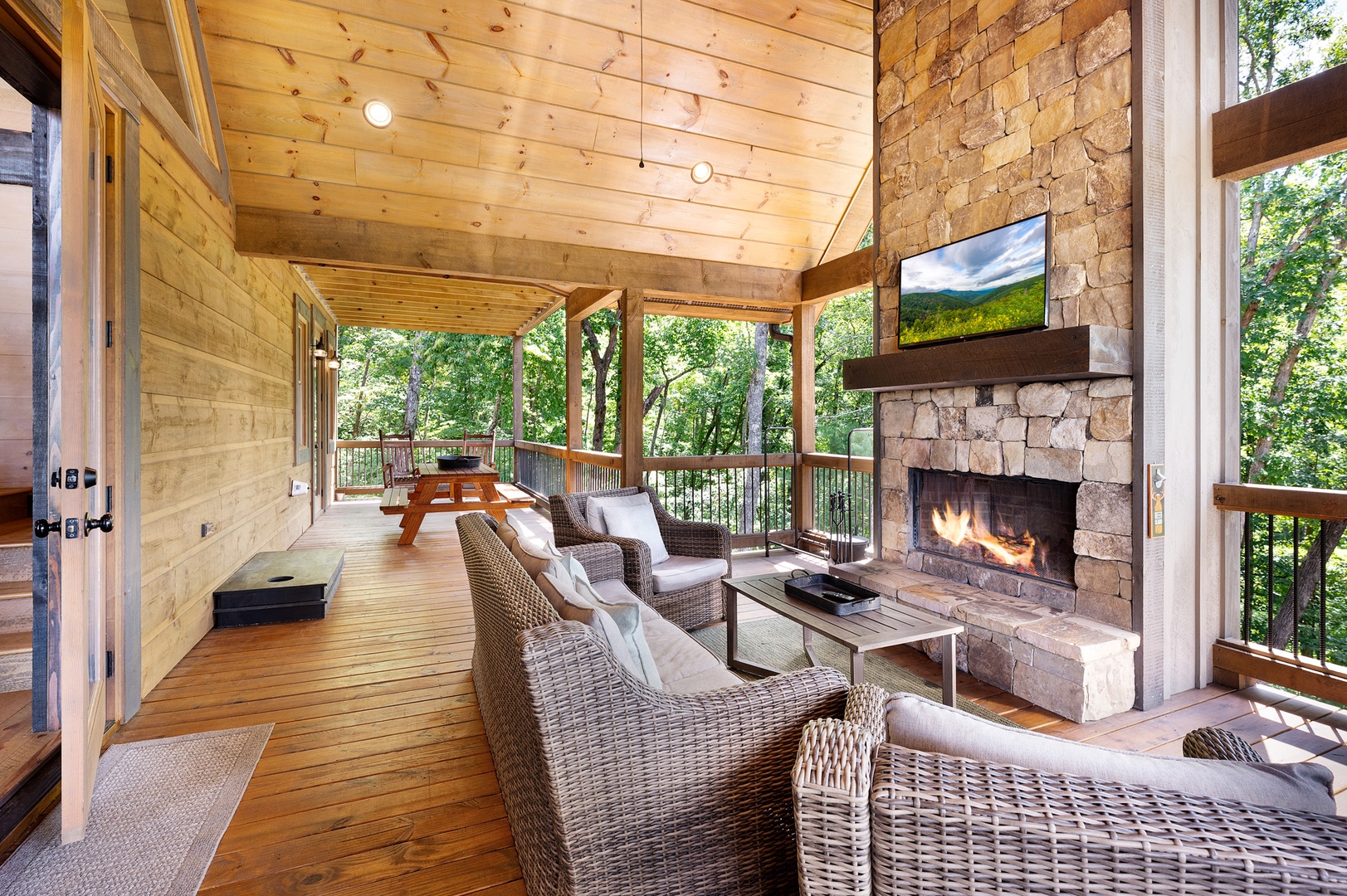 Mountain Echoes- Outdoor fireplace with deck seating and TV