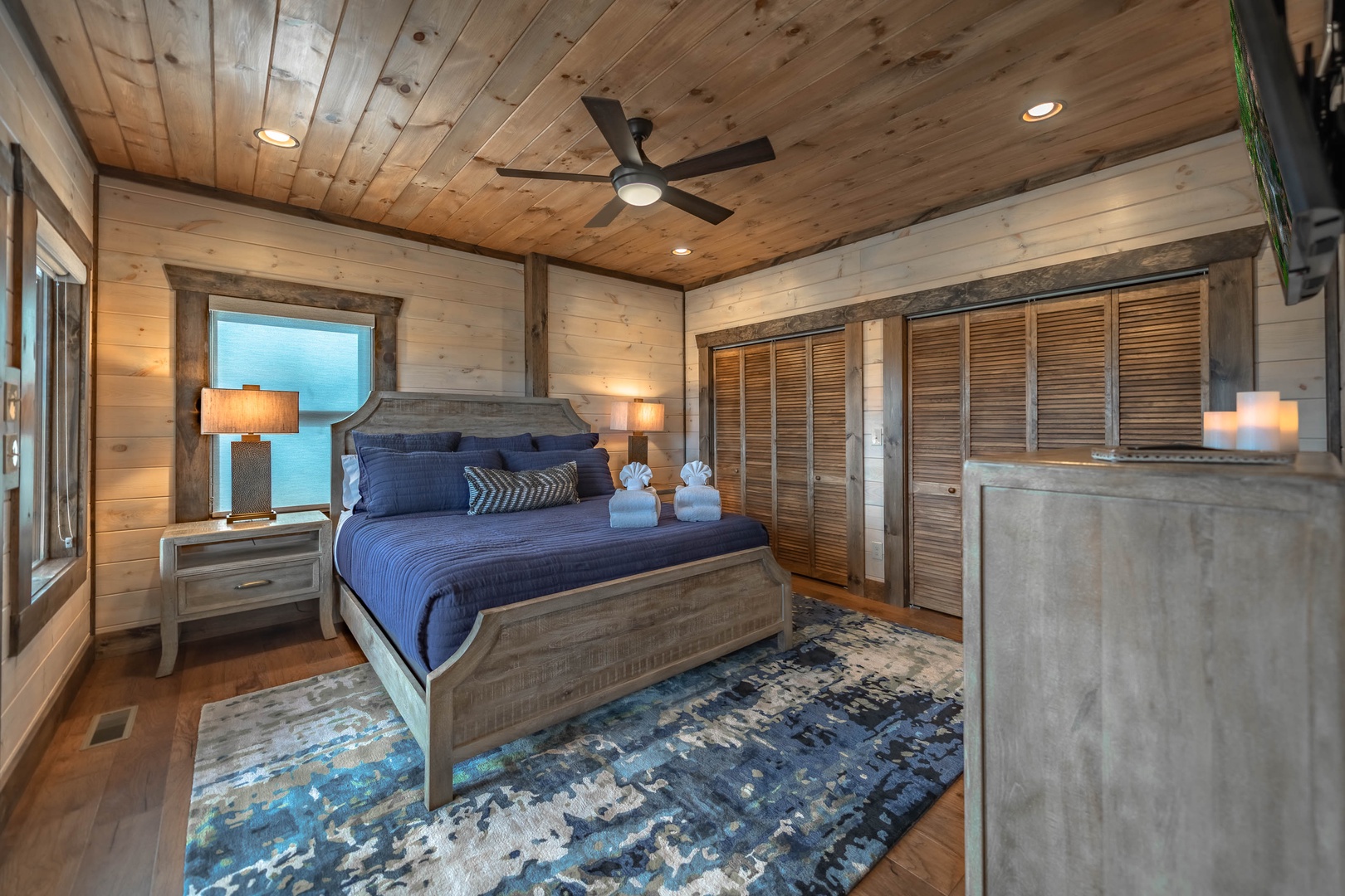 The Ridgeline Retreat- Lower level king bedroom with a mounted TV