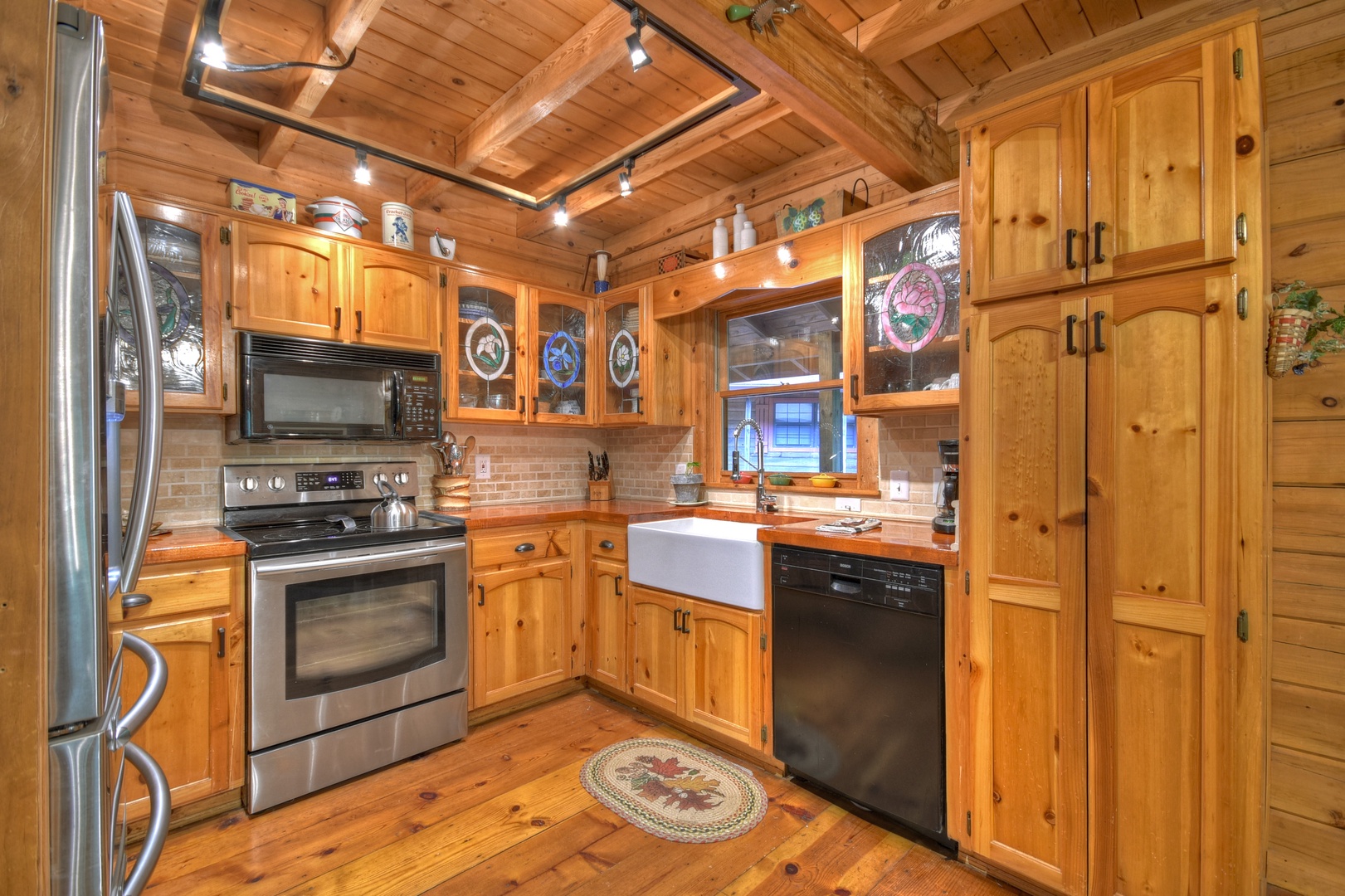 Falling Leaf- Kitchen area with rustic cabinets and appliances