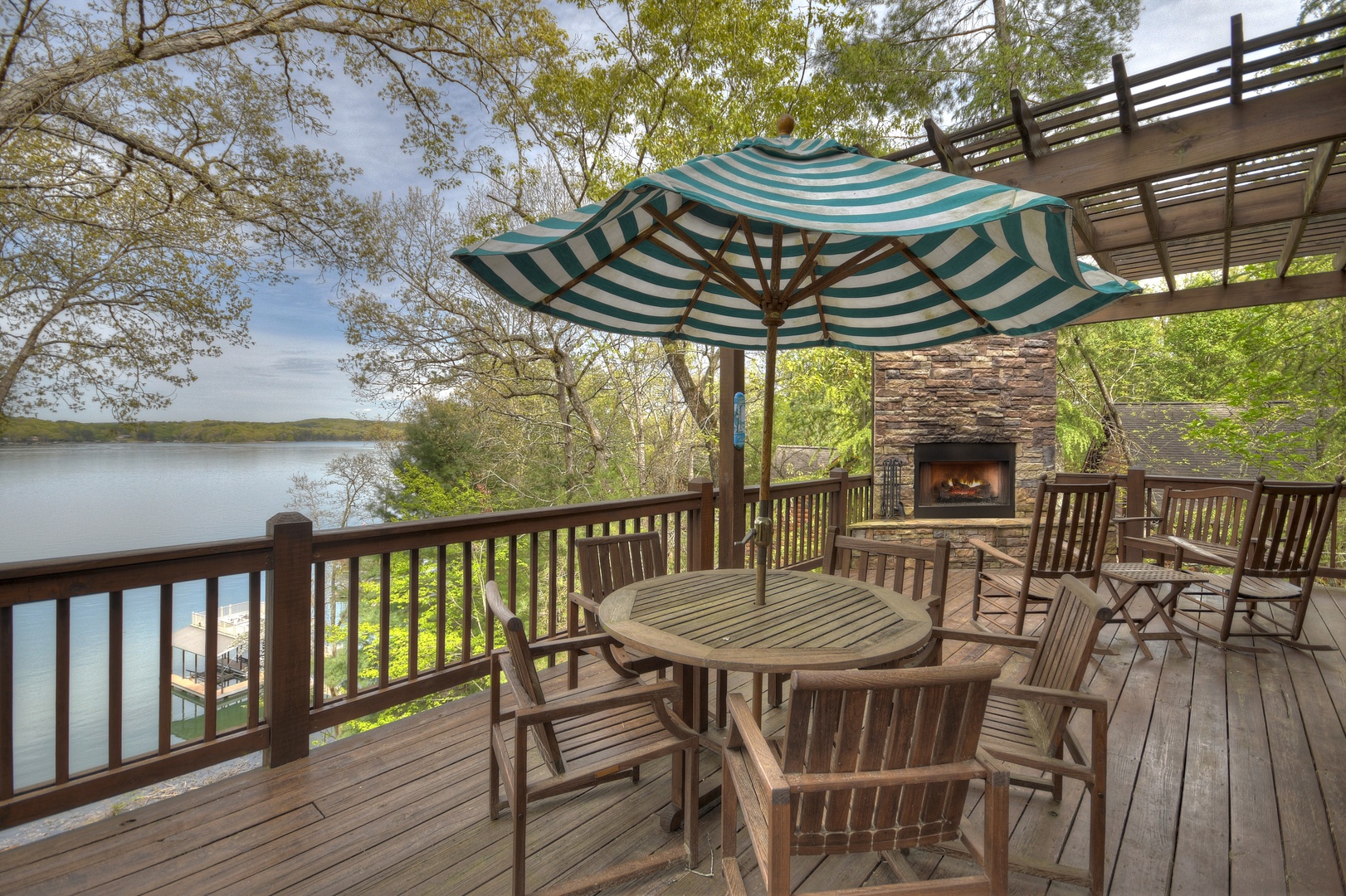 When In Rome- Deck with table and chair seating, fireplace and a lake view