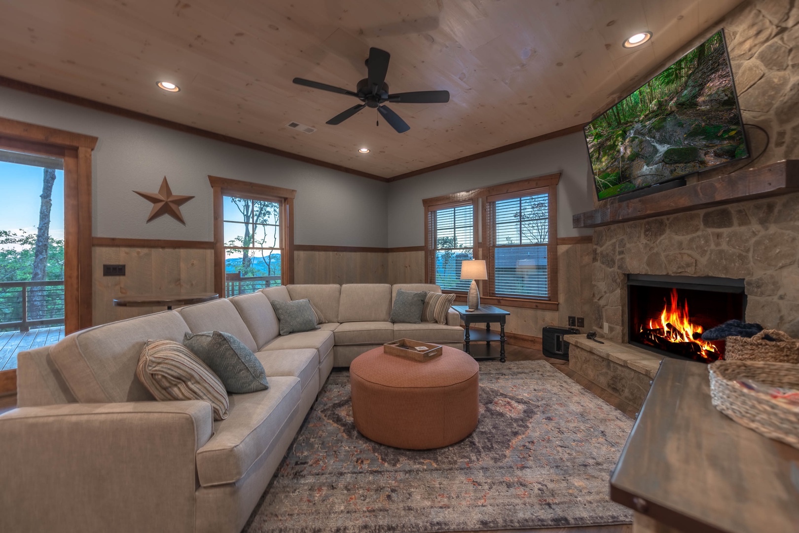 Southern Star- Lower level living room area with large fireplace and TV