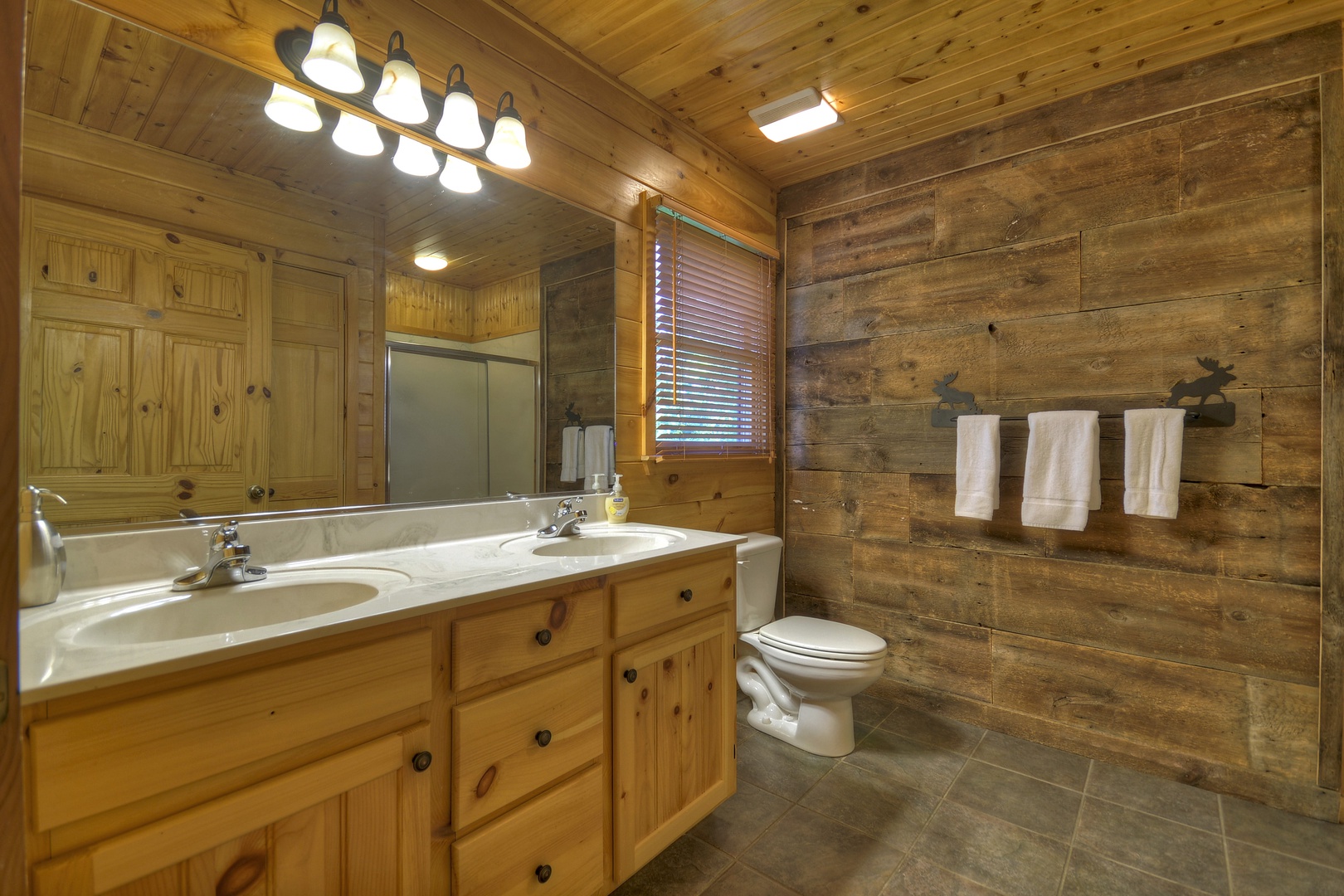 Grand  Mountain Lodge- Upper level attached bathroom with double vanity and toilet