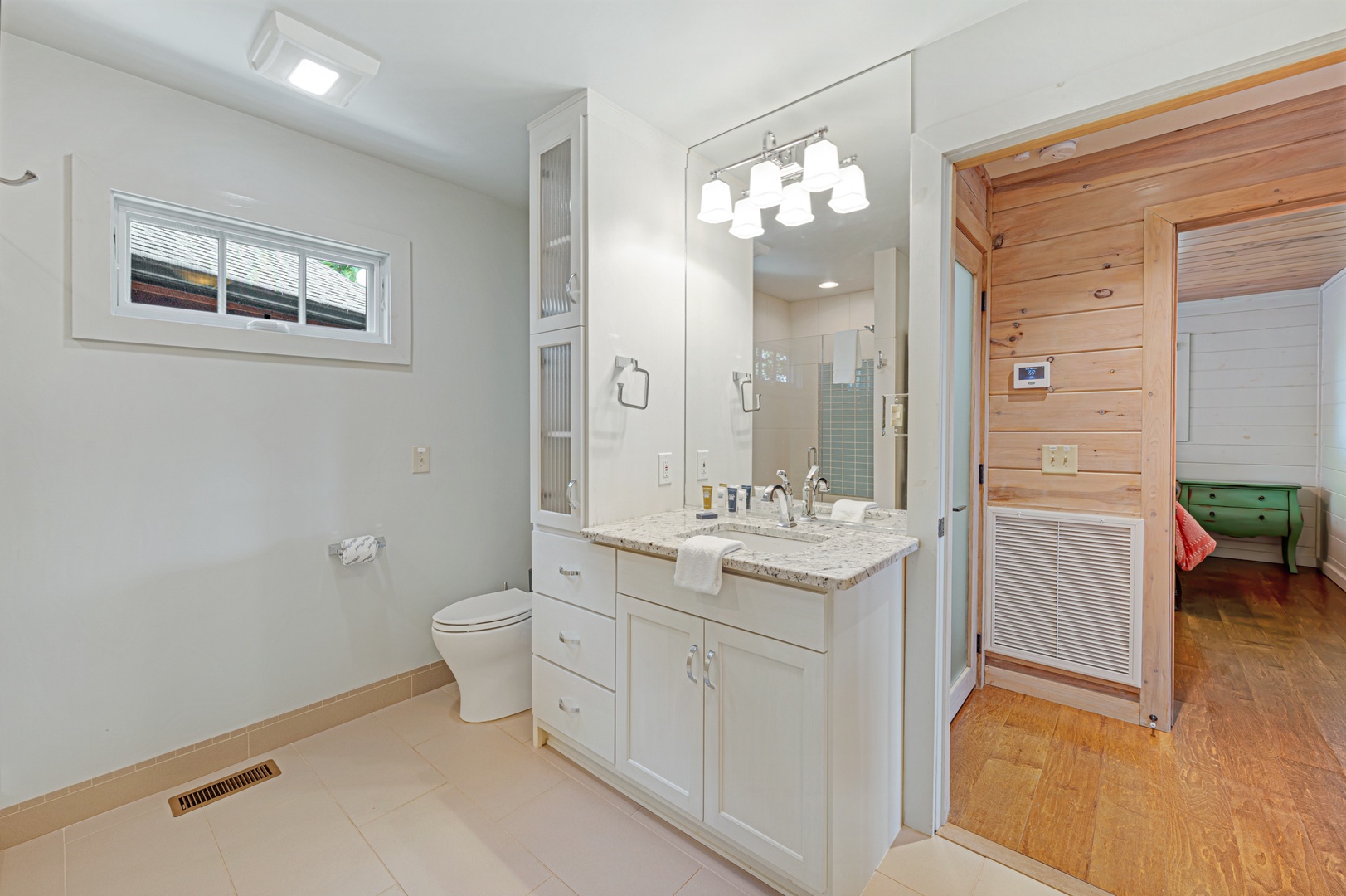 Kricket's Overlook- Entry level bathroom with vanity sink, mirror and toilet