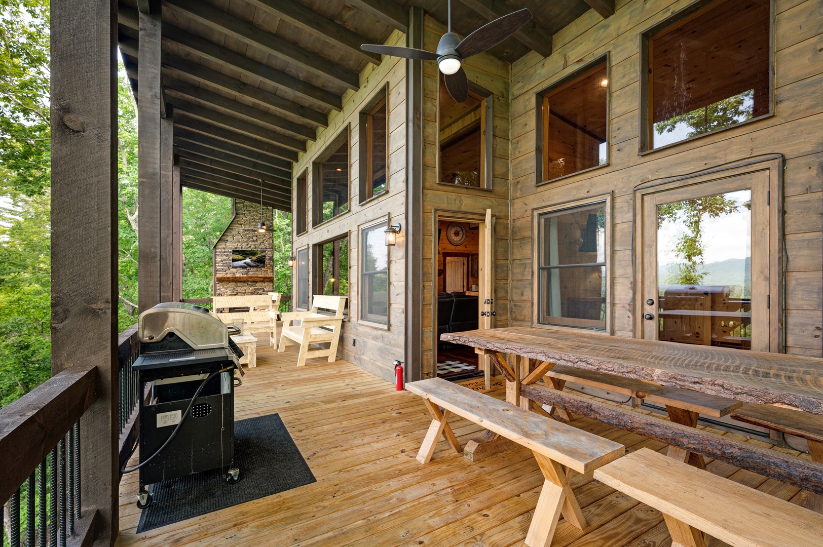Feather & Fawn Lodge- Upper deck outdoor dining area with a grill and cabin access