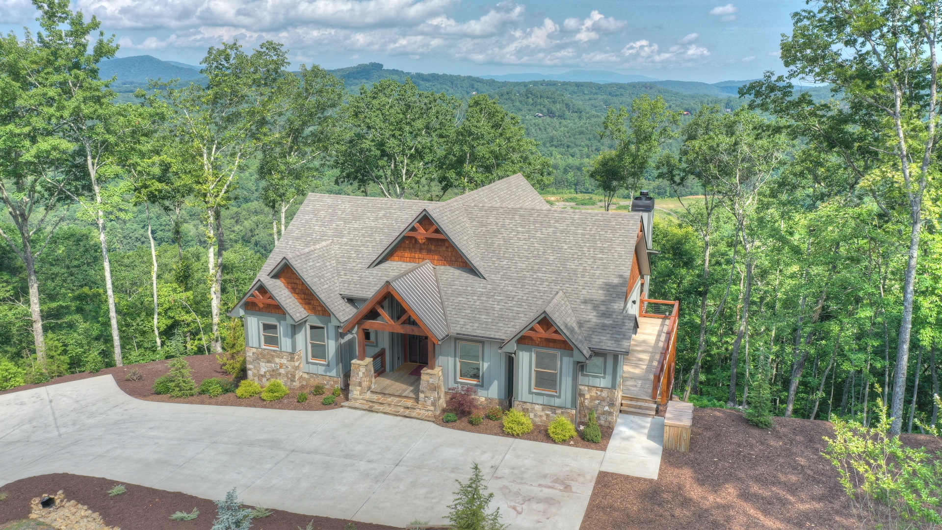 New Heights- Aerial view overlooking the cabin onto the long range mountain views