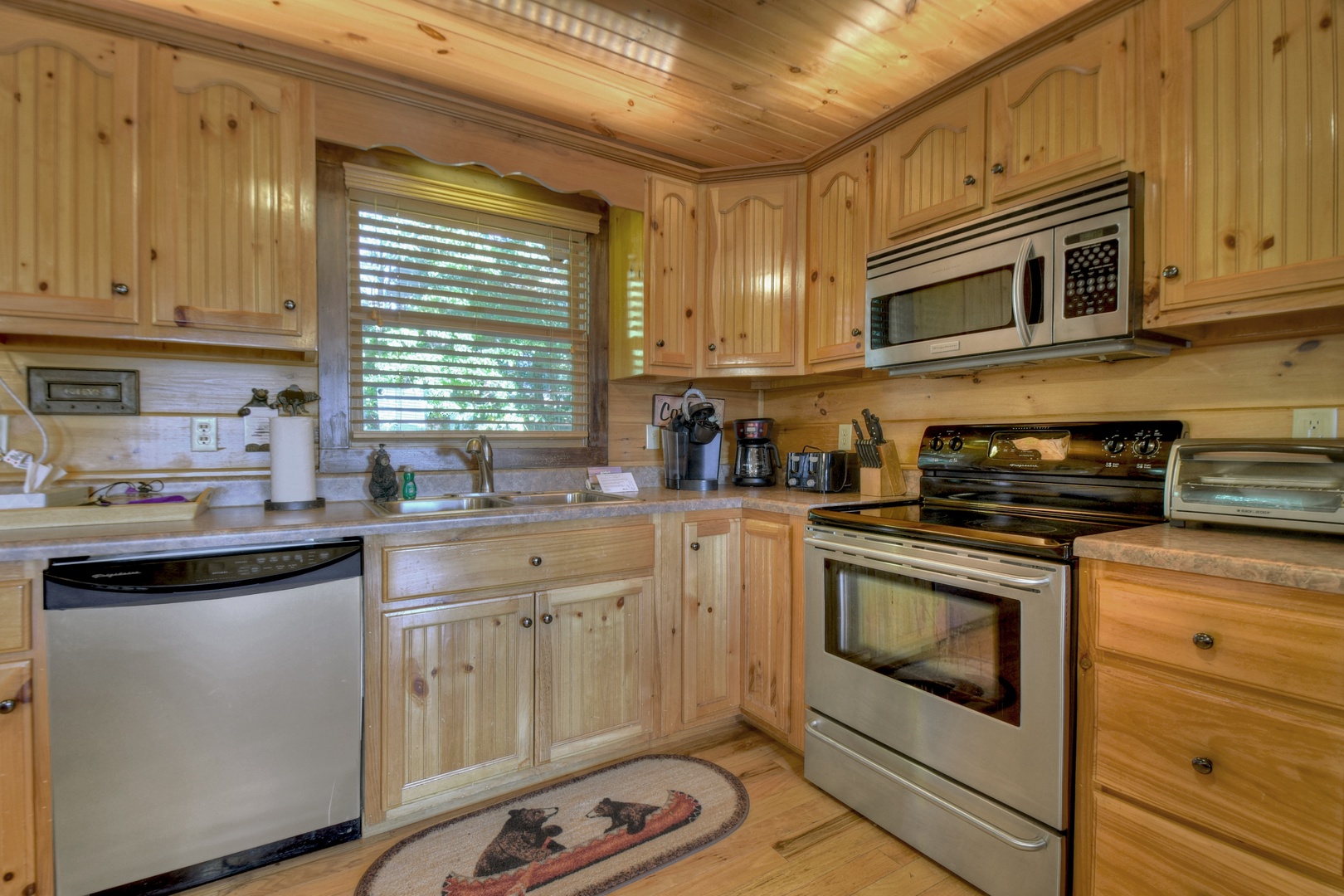 Sunrock Mountain Hideaway- Stainless steel appliances with rustic cabinets