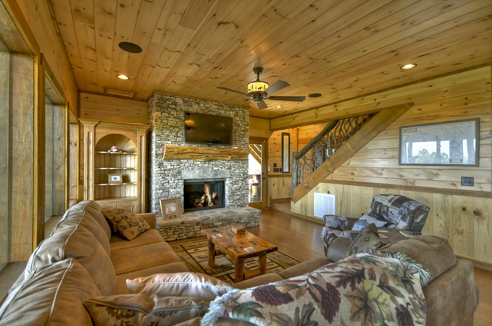 The Vue Over Blue Ridge- Lower level living area with a fireplace and TV