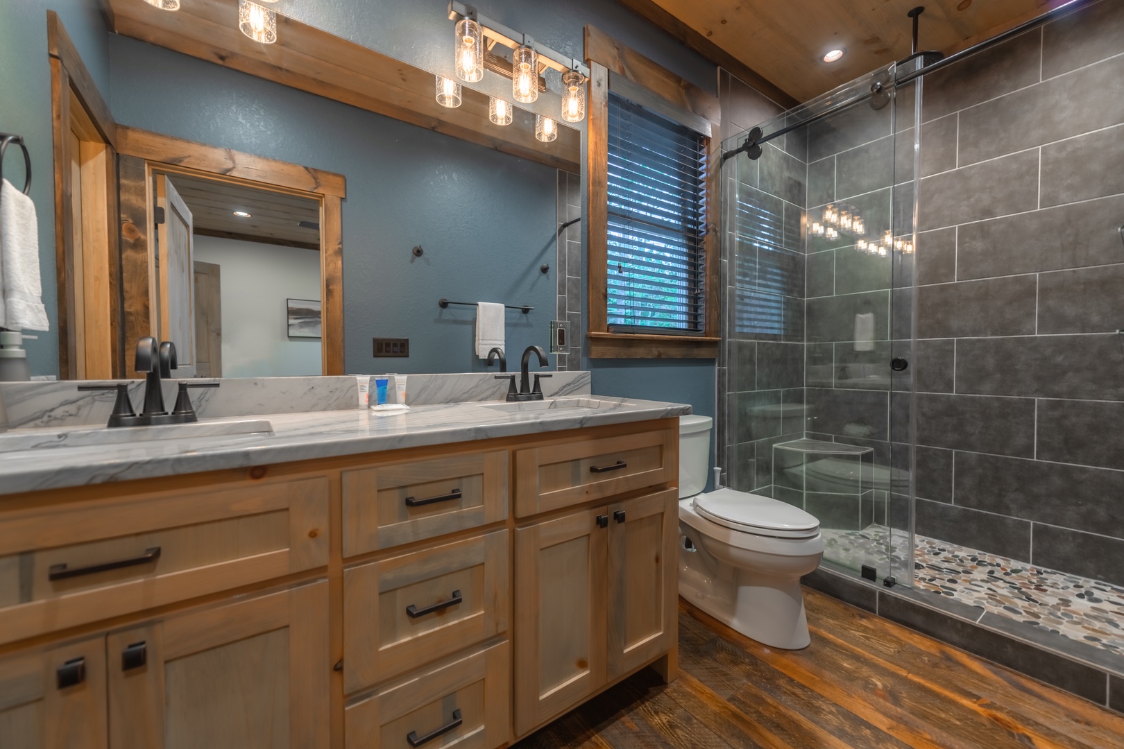 Highland Escape- Main level master bathroom with walk in shower, and double vanity sink