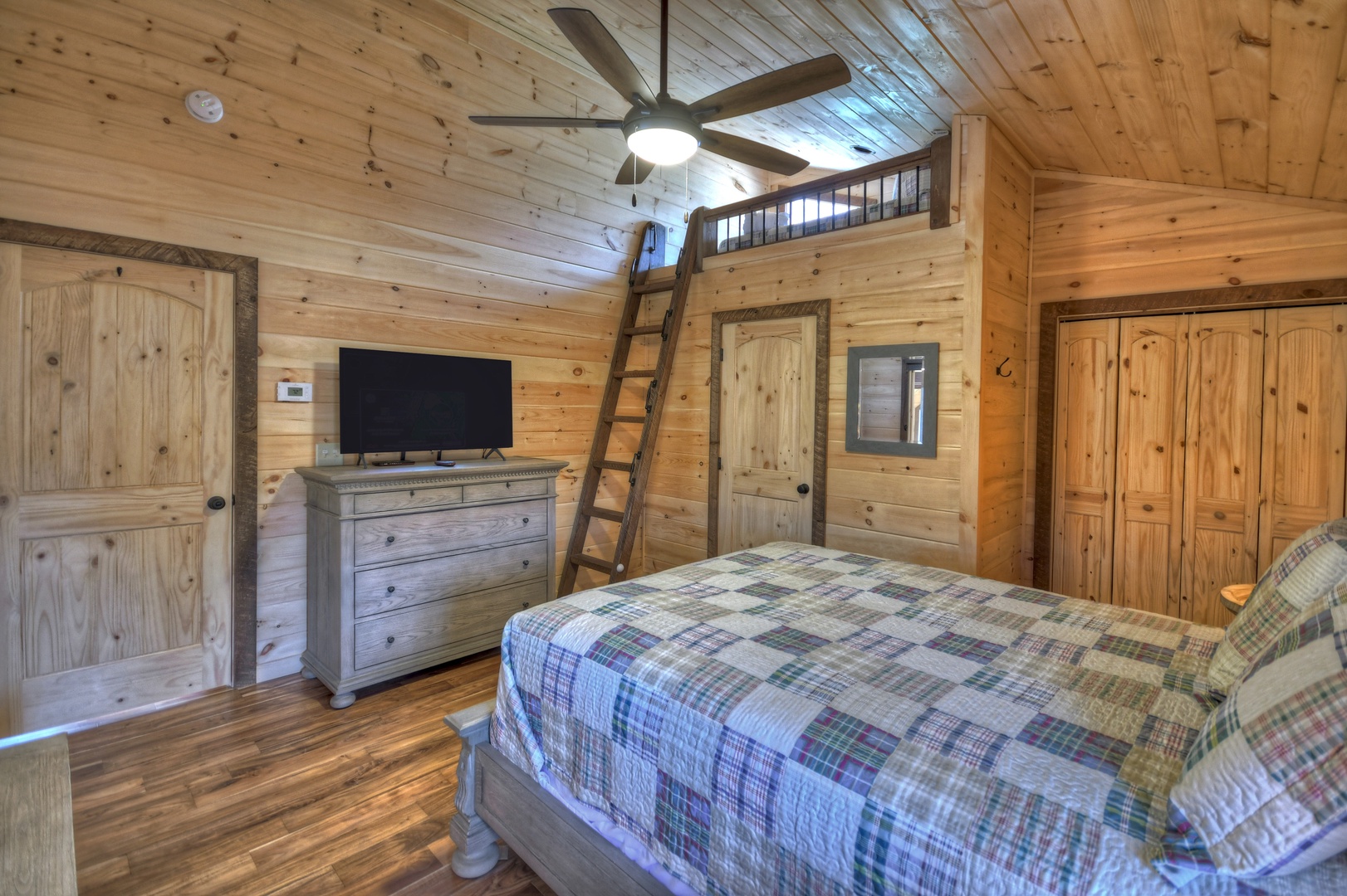 Whisky Creek Retreat- Upper queen bedroom with a TV and loft area