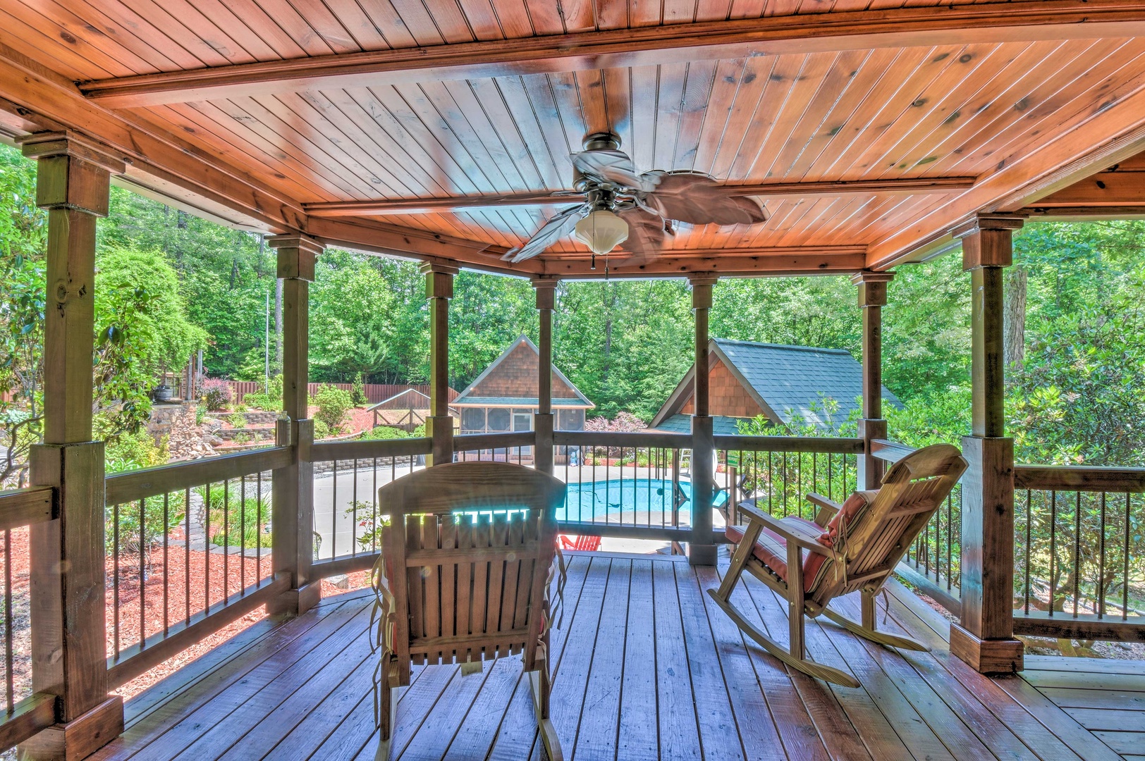 Deer Watch Lodge- Pool house view with rocking chair seating