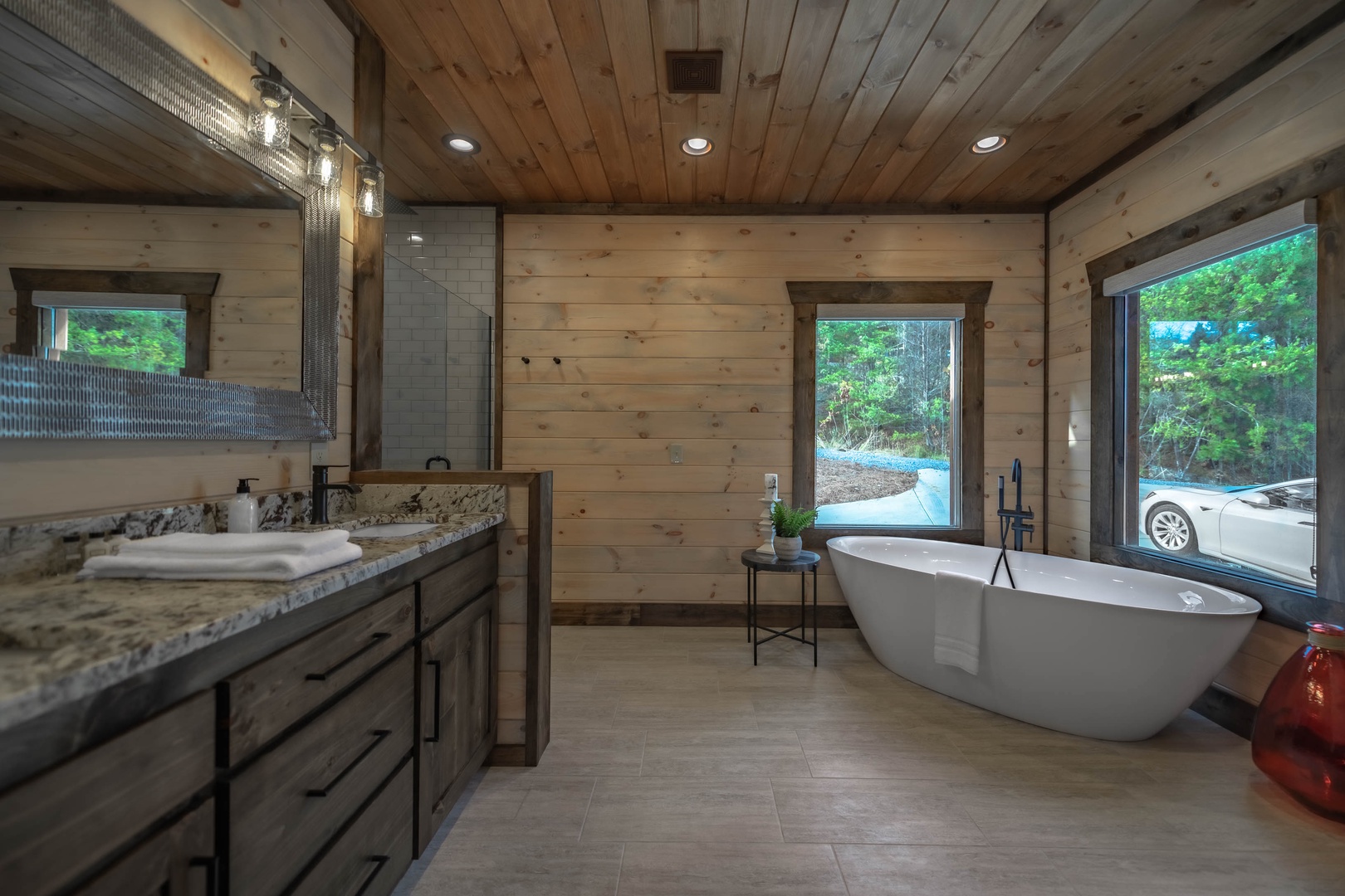 The Ridgeline Retreat- Main level master bathroom suite with a soaker tub