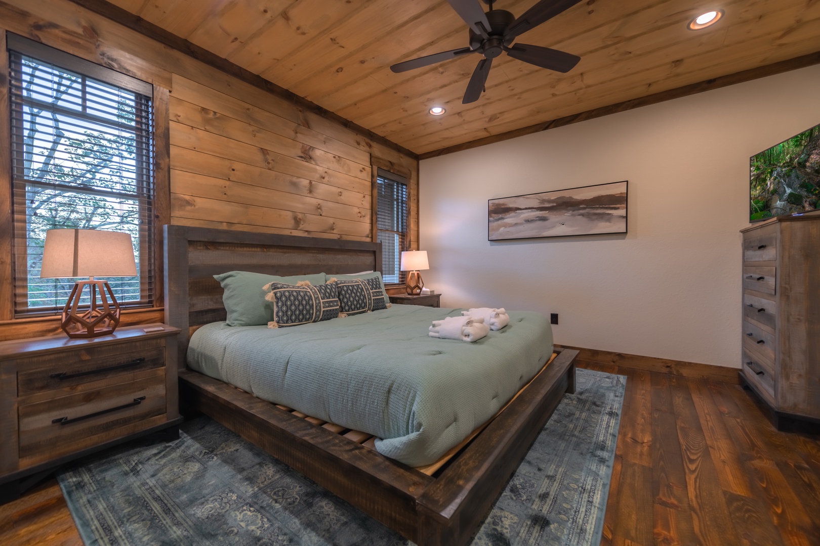 Highland Escape- Main level master bedroom with a TV