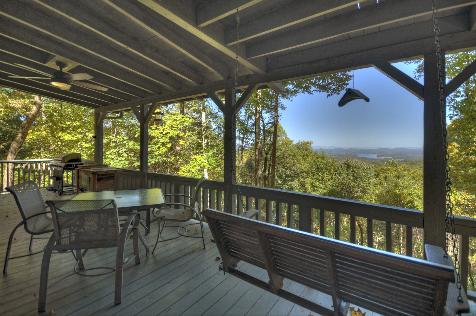 Ridgetop Pointaview- Entry level deck area with outdoor dining and a bench swing