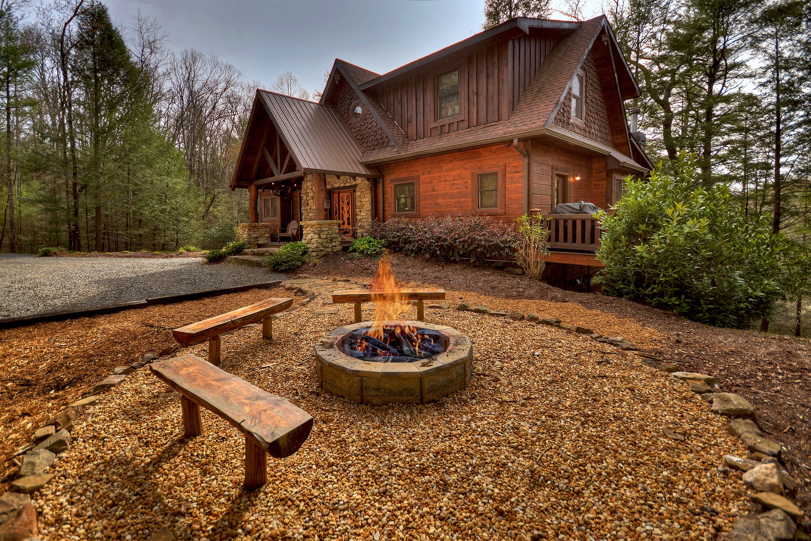 Reel Creek Lodge- Firepit area with outdoor seating and view of the cabin