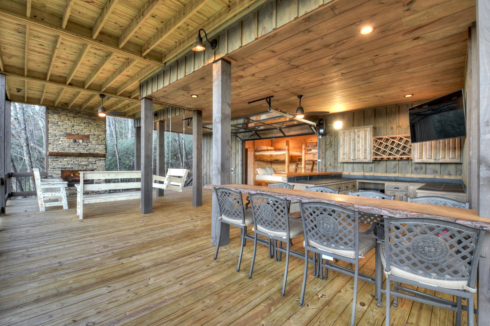 Feather & Fawn Lodge- Lower level deck fireplace and outdoor dining and seating