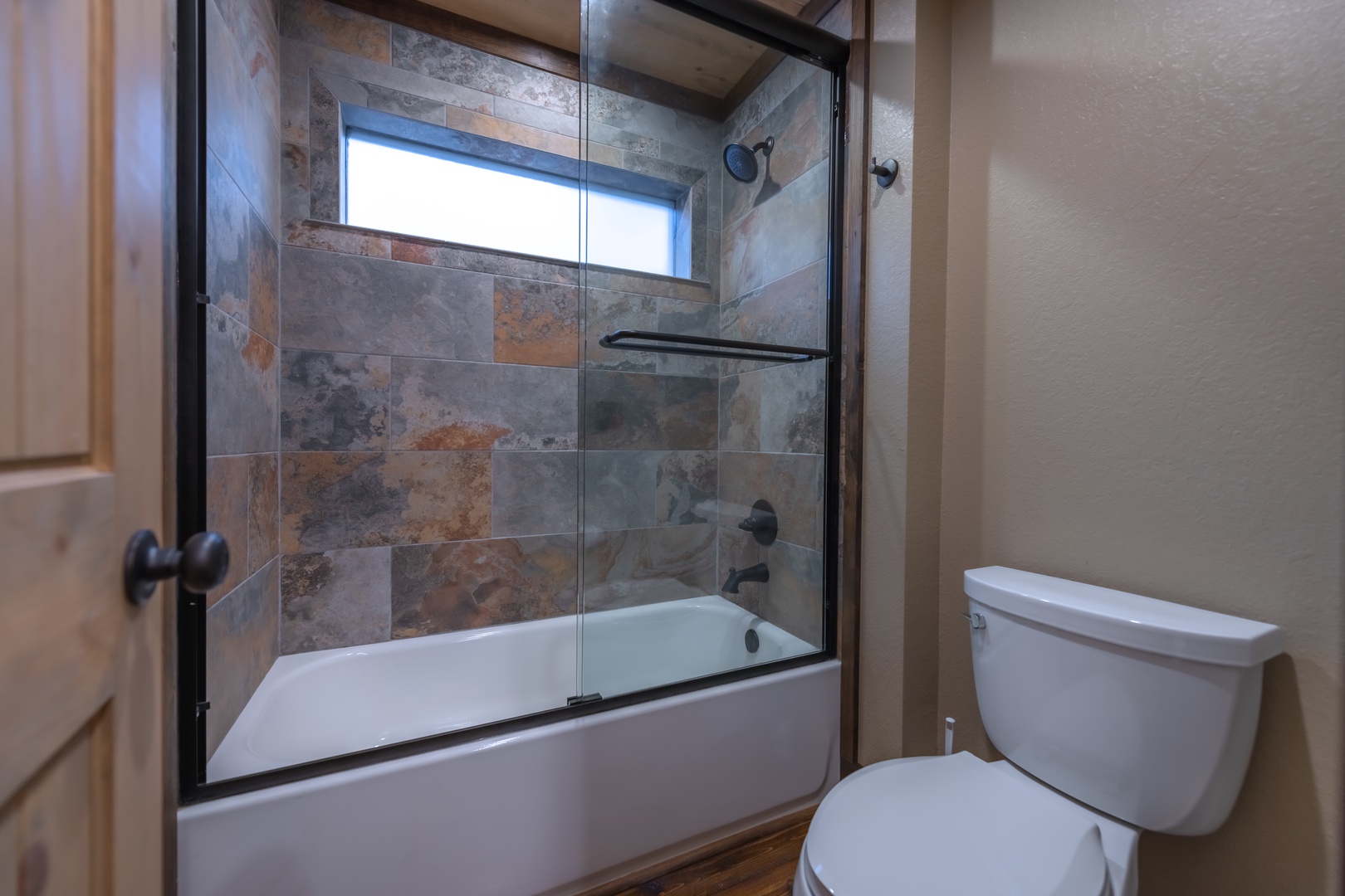 Highland Escape- Upstairs master bathroom with tile shower and toilet