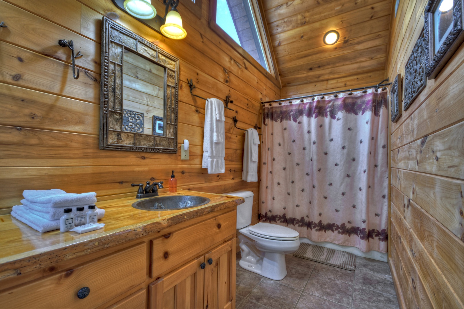 Aska Lodge- Upper level master bath with a step in shower and toilet