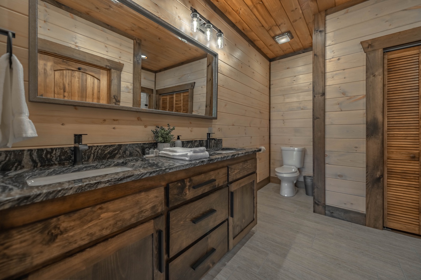 The Ridgeline Retreat- Lower level full bathroom with double vanity sink