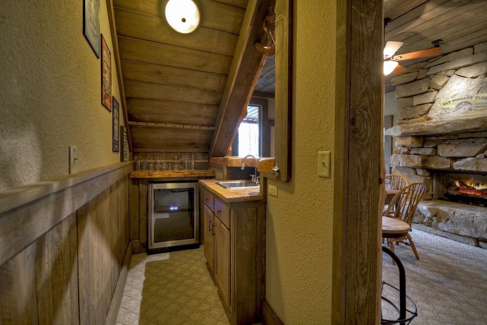 Reel Creek Lodge- Lower level wine chiller with cabinet storage and sink area