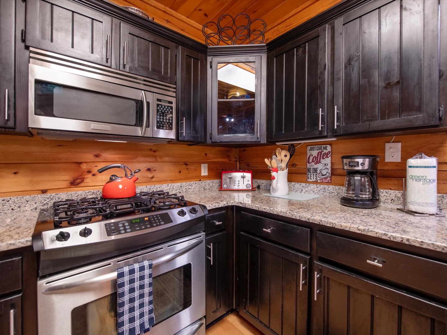 Aska Bliss- Stovetop and microwave in the kitchen with decor