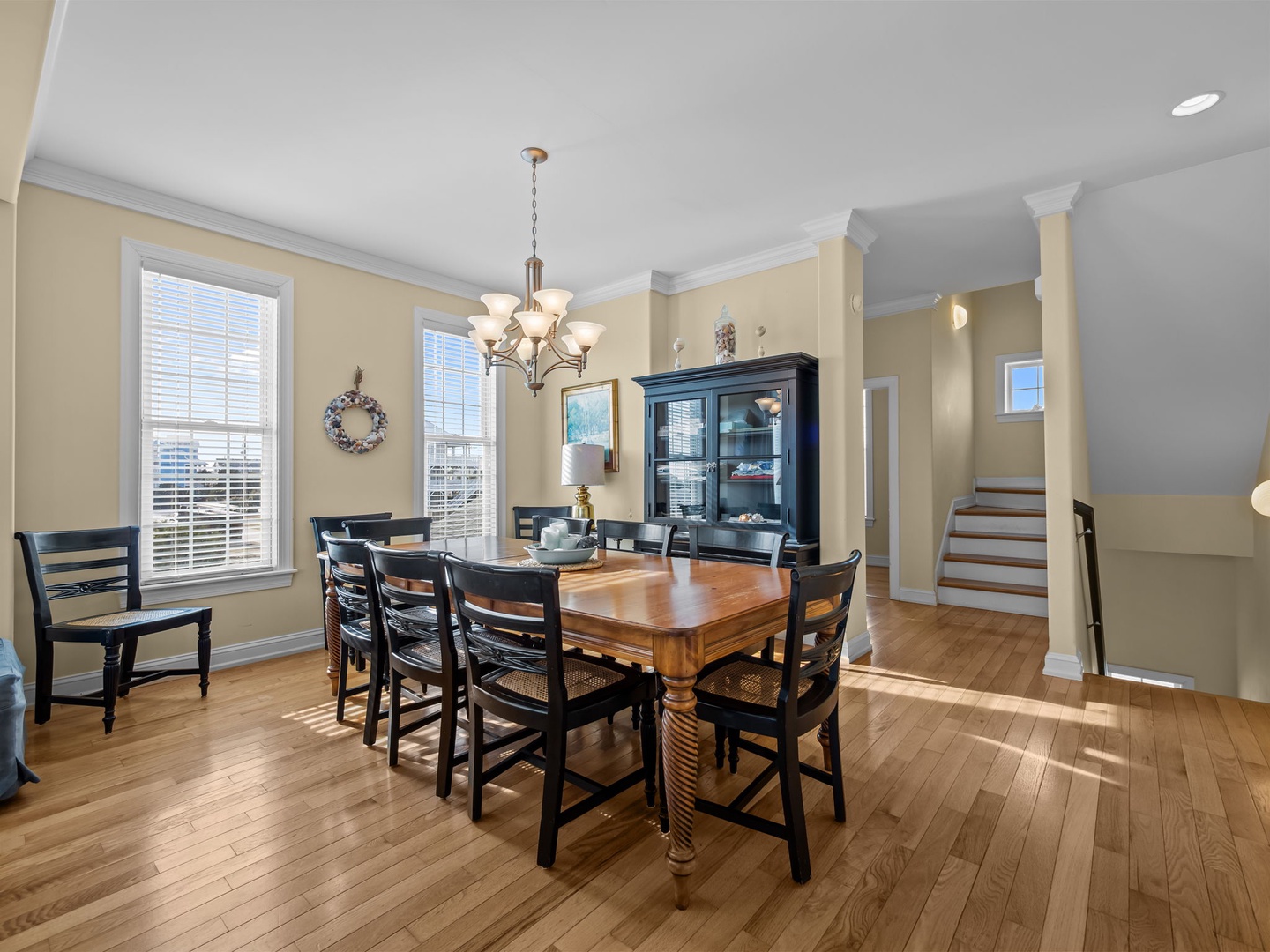 Gather around your elegant dining table where natural light streams through large windows, creating the perfect setting for memorable meals together.