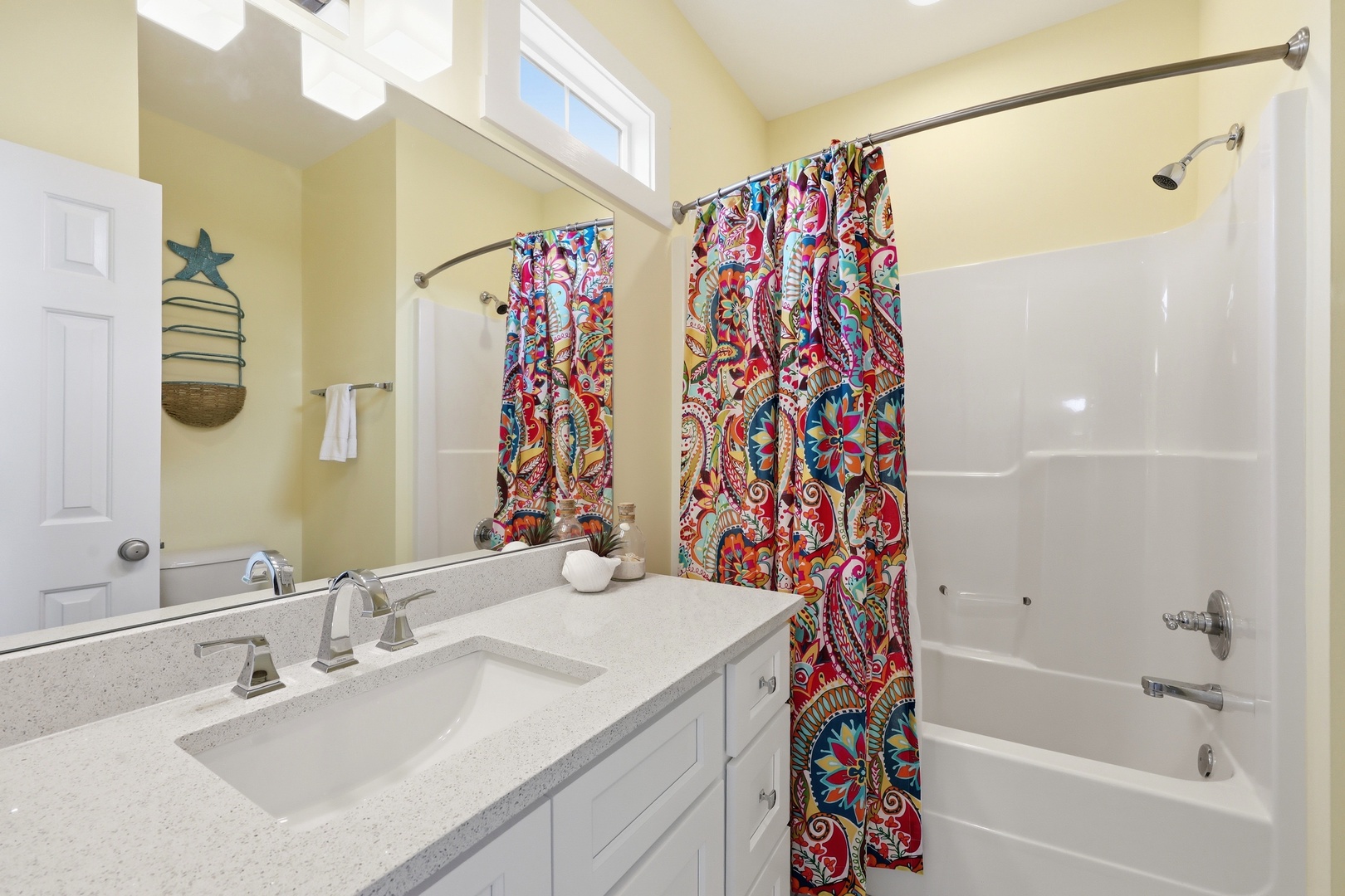 Refresh in your cheerful bathroom with dual sinks, a soaking tub, and lively coastal charm—perfect for starting and ending your day in comfort.