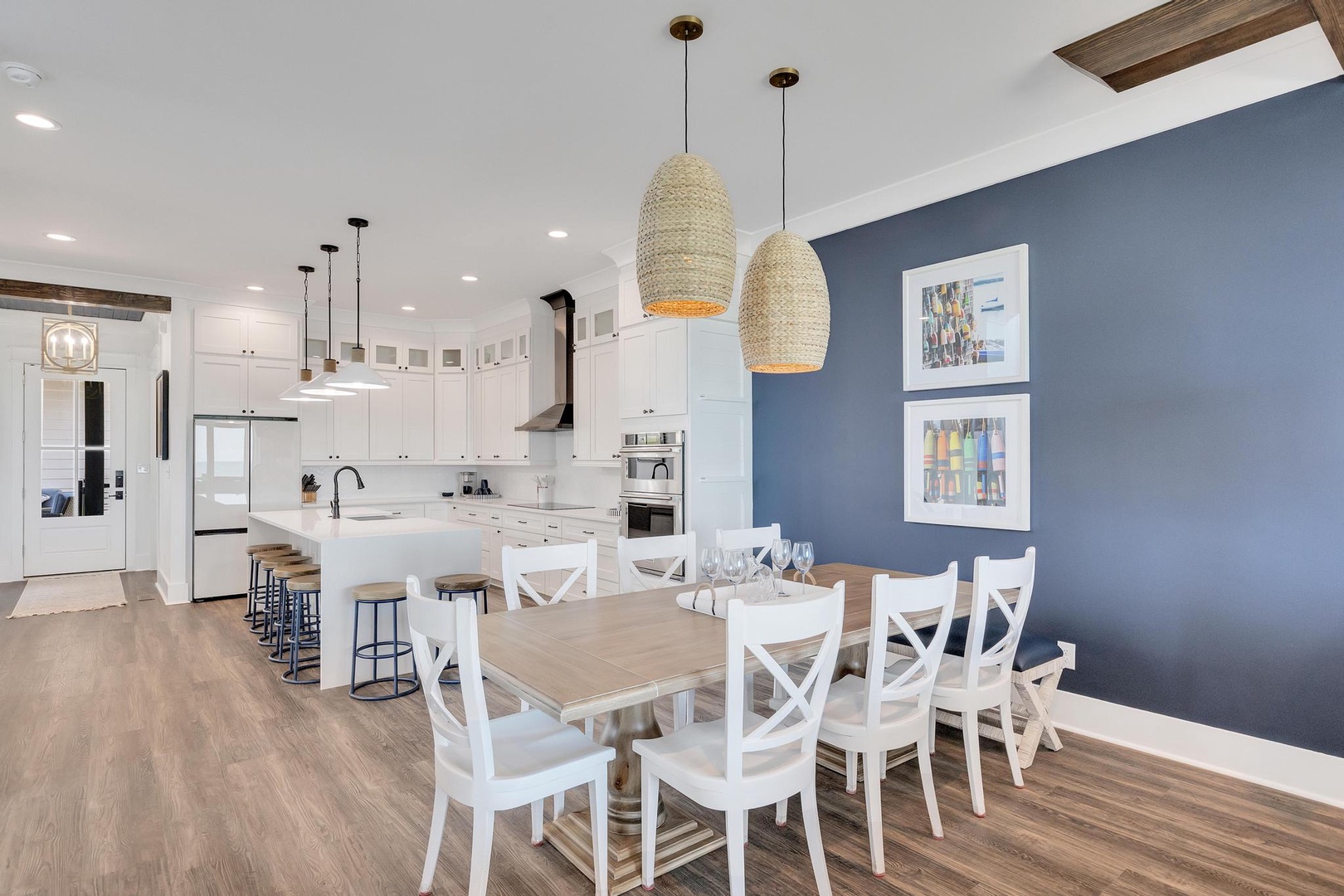 Gather your crew at this spacious dining table or chat at the kitchen island—your bright, open-plan space invites easy conversation and memorable meals together.
