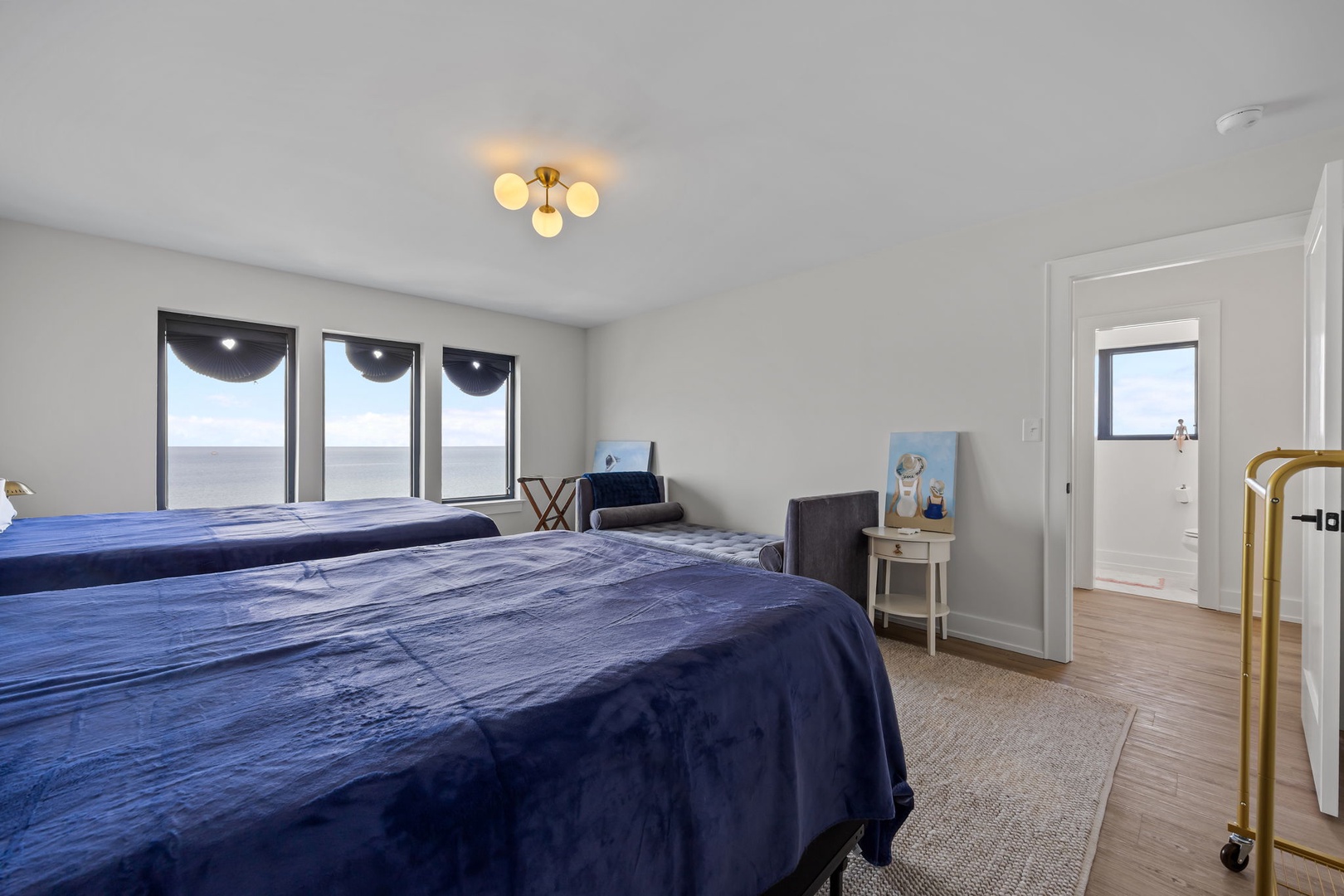 Drift off in your serene bedroom with panoramic windows framing endless views and elegant lighting creating the perfect ambiance.