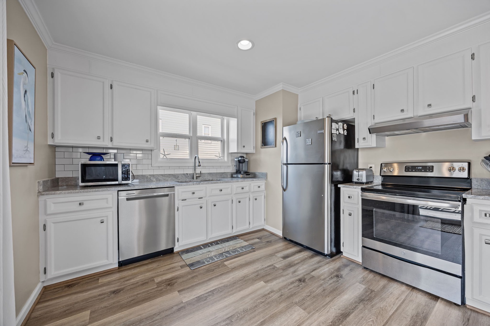 Your fully equipped kitchen features stainless steel appliances, granite countertops, and crisp white cabinetry for all your culinary adventures.