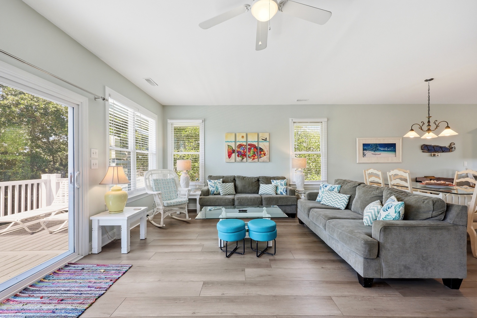 Sink into plush seating and feel the coastal breeze through open deck doors in your bright, airy living space—perfect for gathering after beach adventures.
