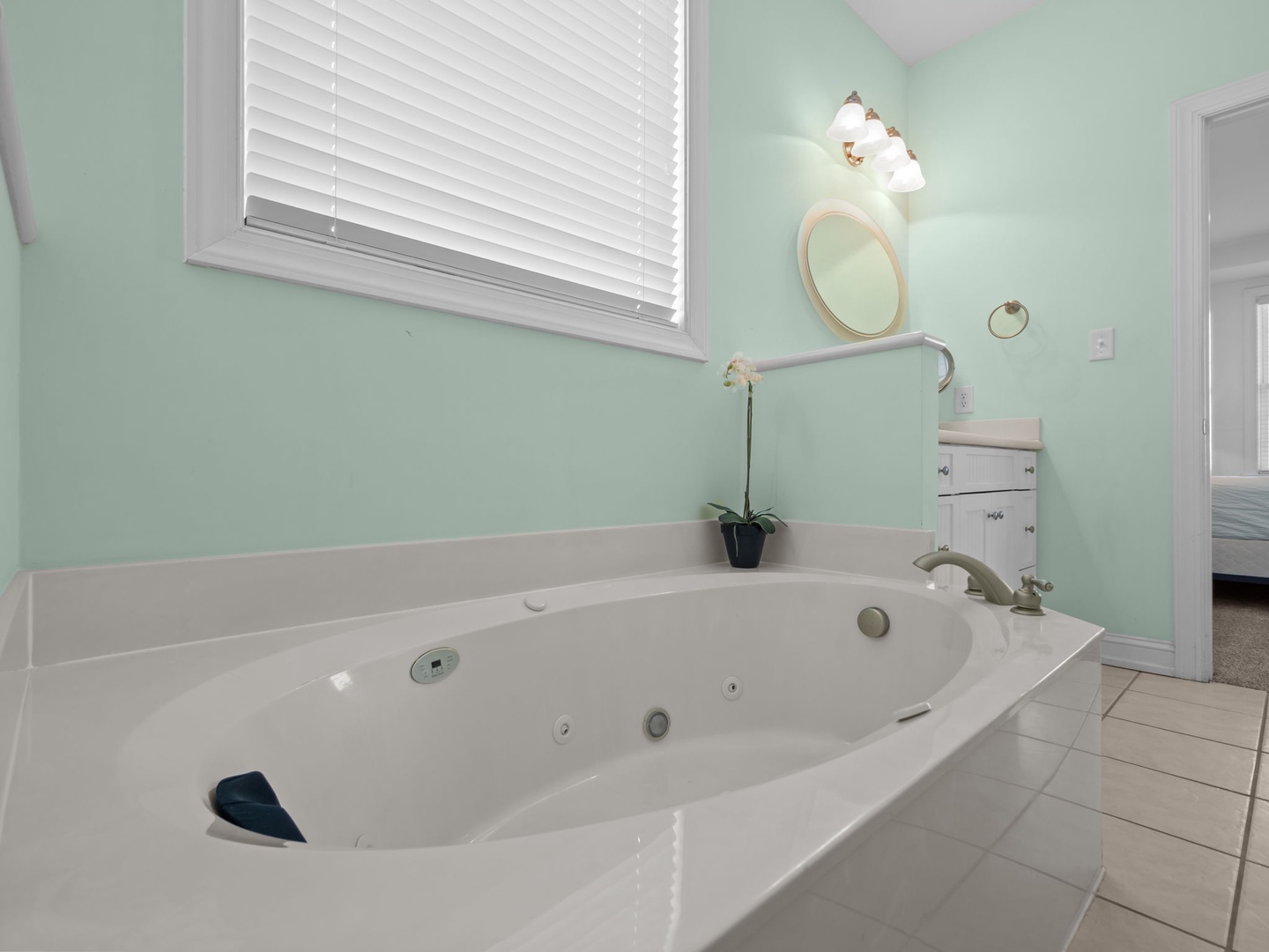 Unwind in your private spa-style jetted tub surrounded by soothing mint walls and natural light.