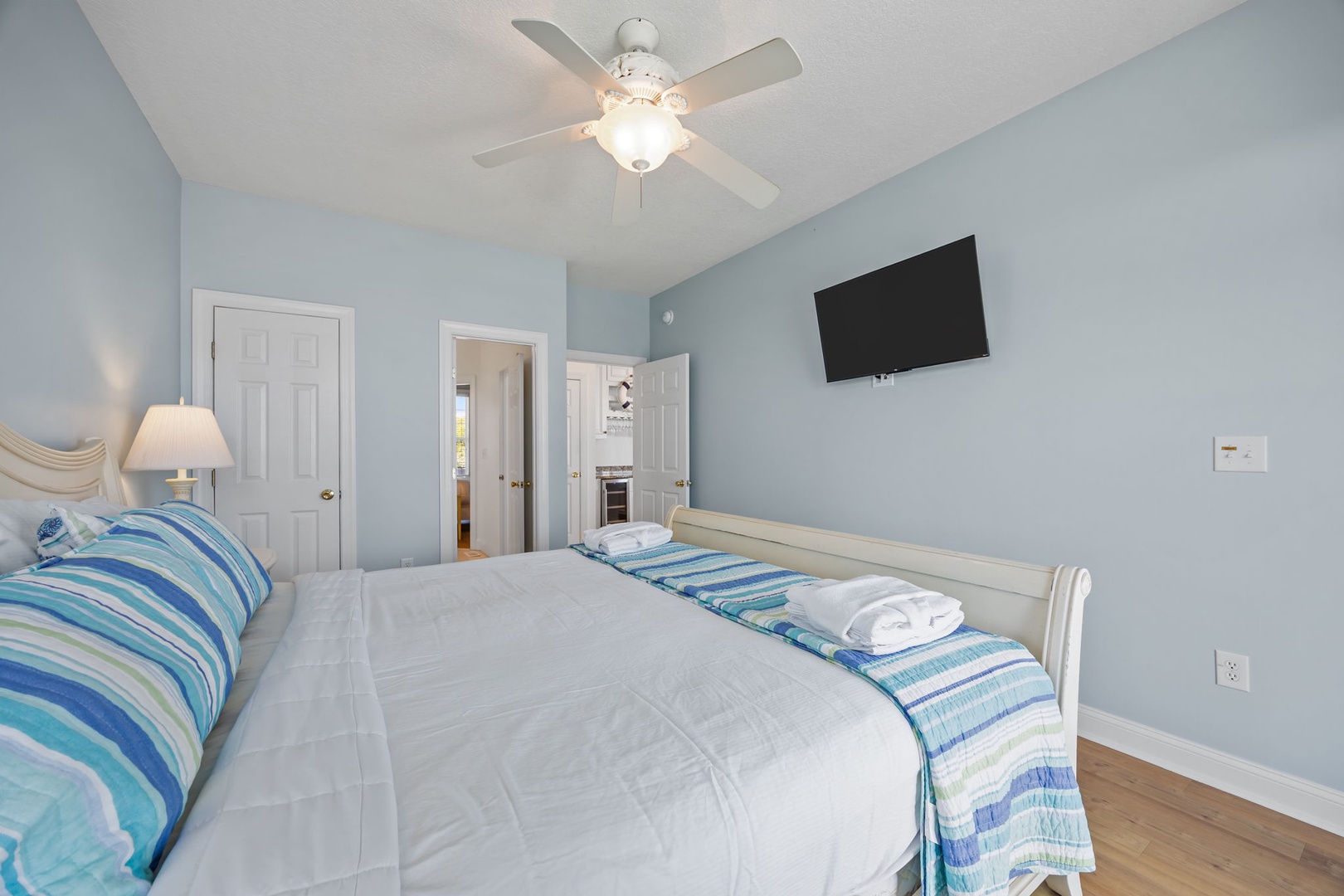 You'll drift off peacefully in this coastal-inspired bedroom with ocean-hued walls and crisp white linens awaiting your arrival.